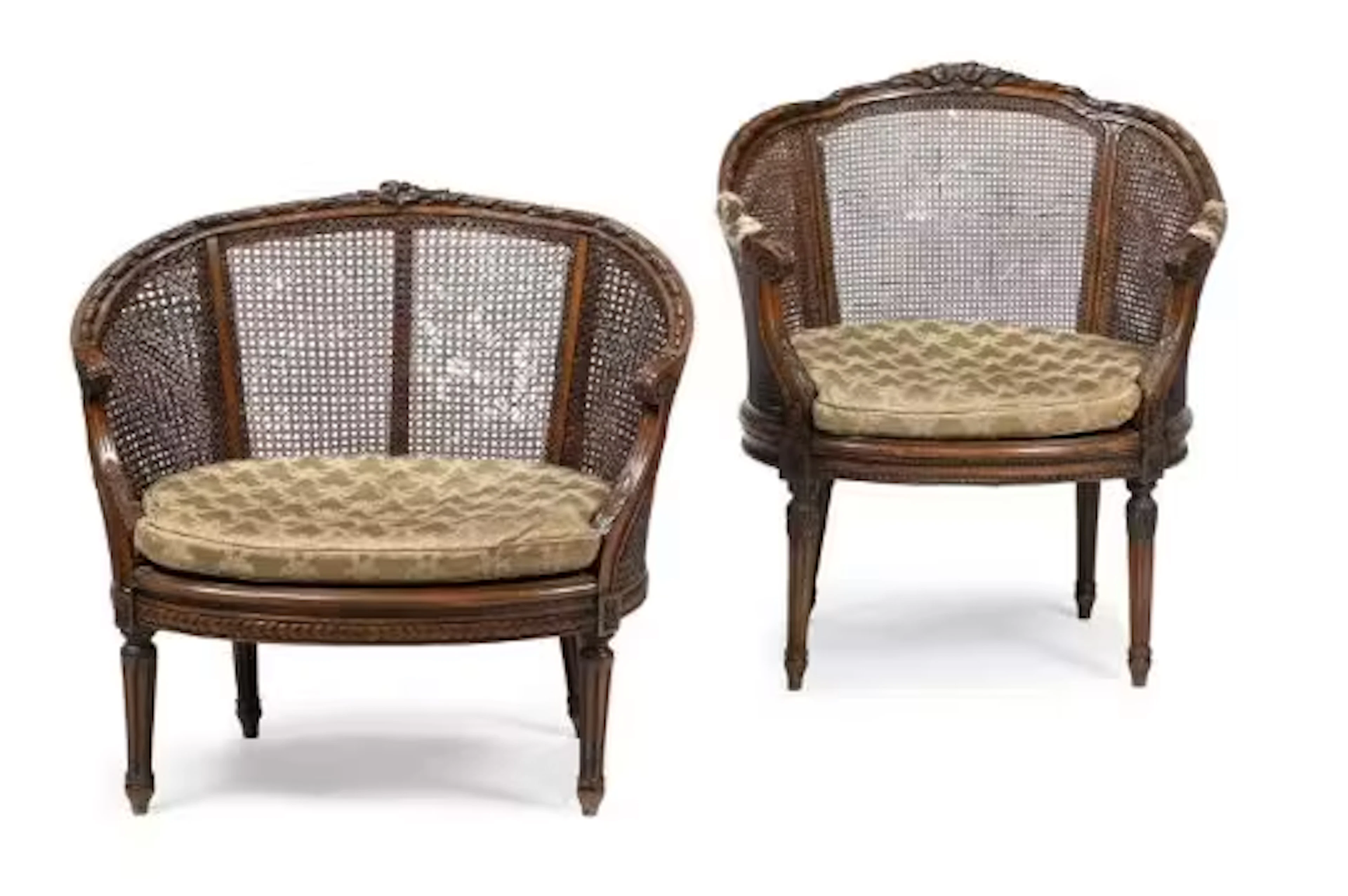 A MATCHED PAIR OF CARVED WALNUT AND CANED BERGERE ARMCHAIRS, LATE