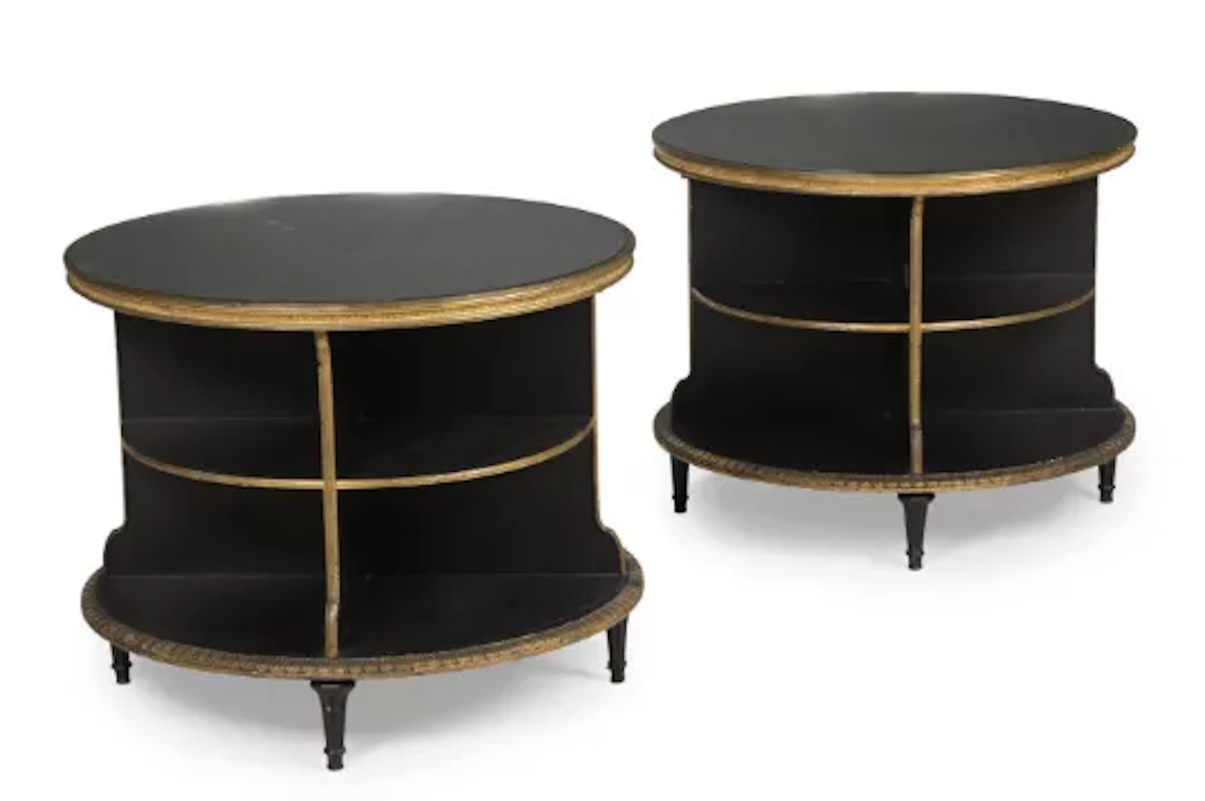 A PAIR OF EBONISED AND PARCEL GILT CIRCULAR LOW OCCASIONAL TABLES