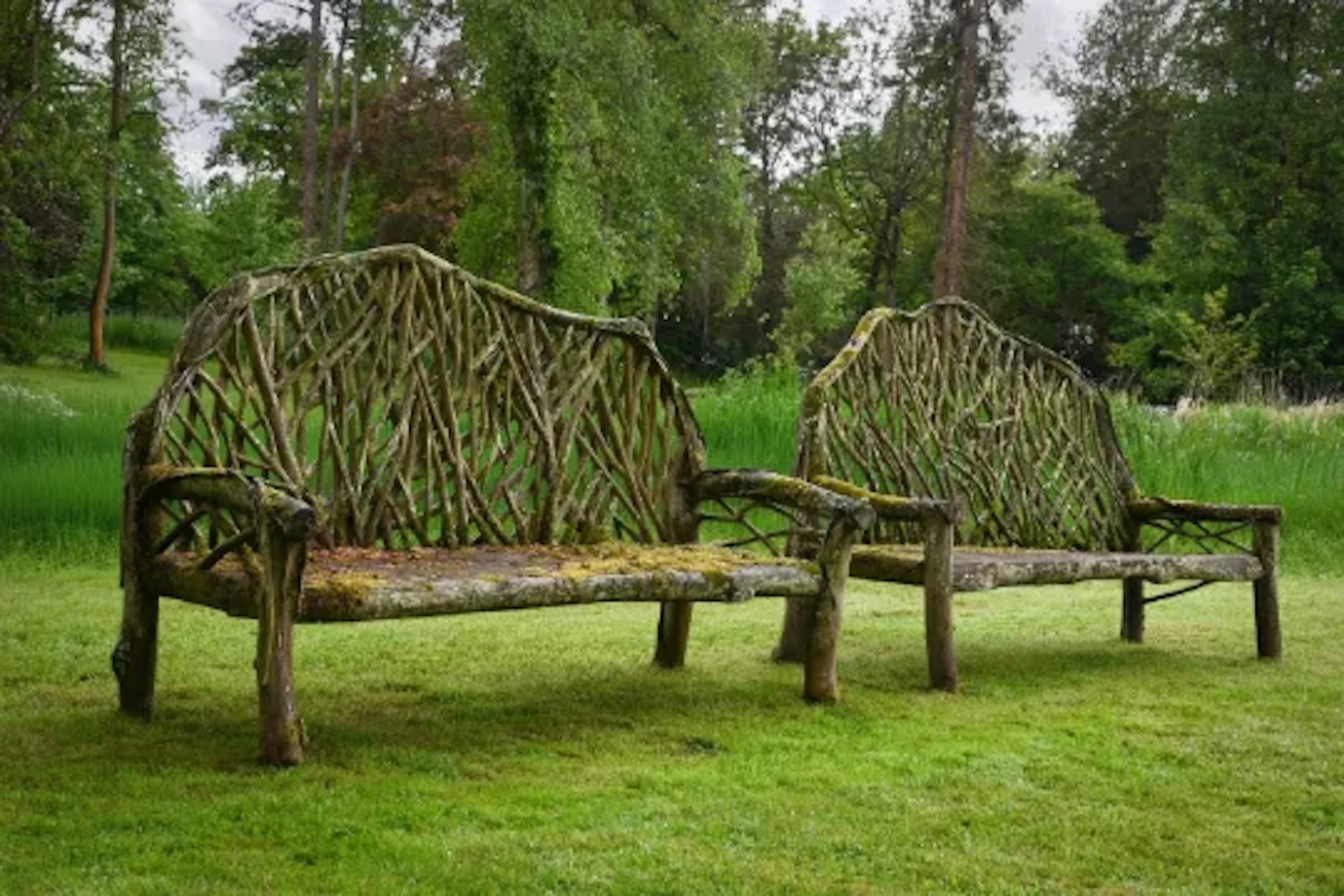 A LARGE PAIR OF TEAK BRANCH COUNTRY HOUSE GARDEN BENCHES, CONTEMPORARY