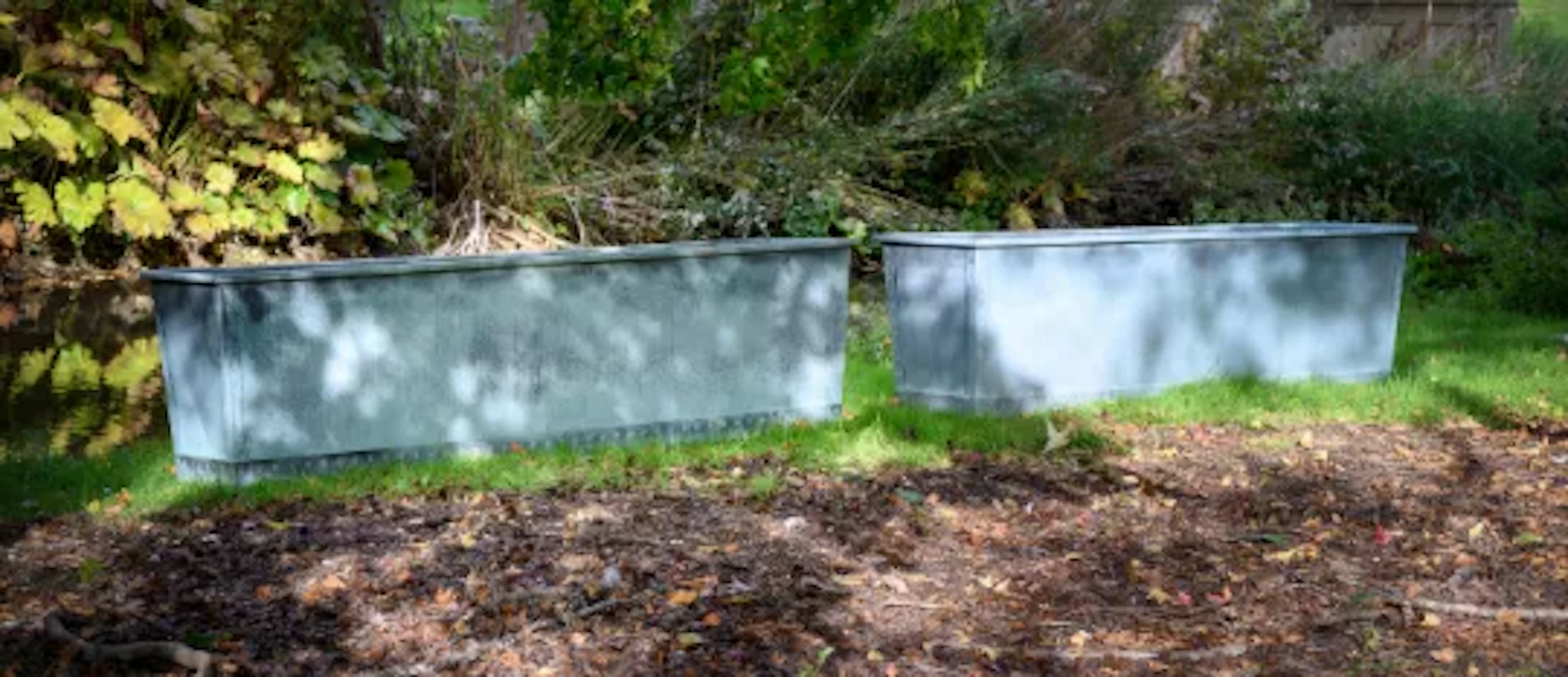 A LARGE PAIR OF PATINATED COPPER AND RIVETED RECTANGULAR PLANTERS, CONTEMPORARY