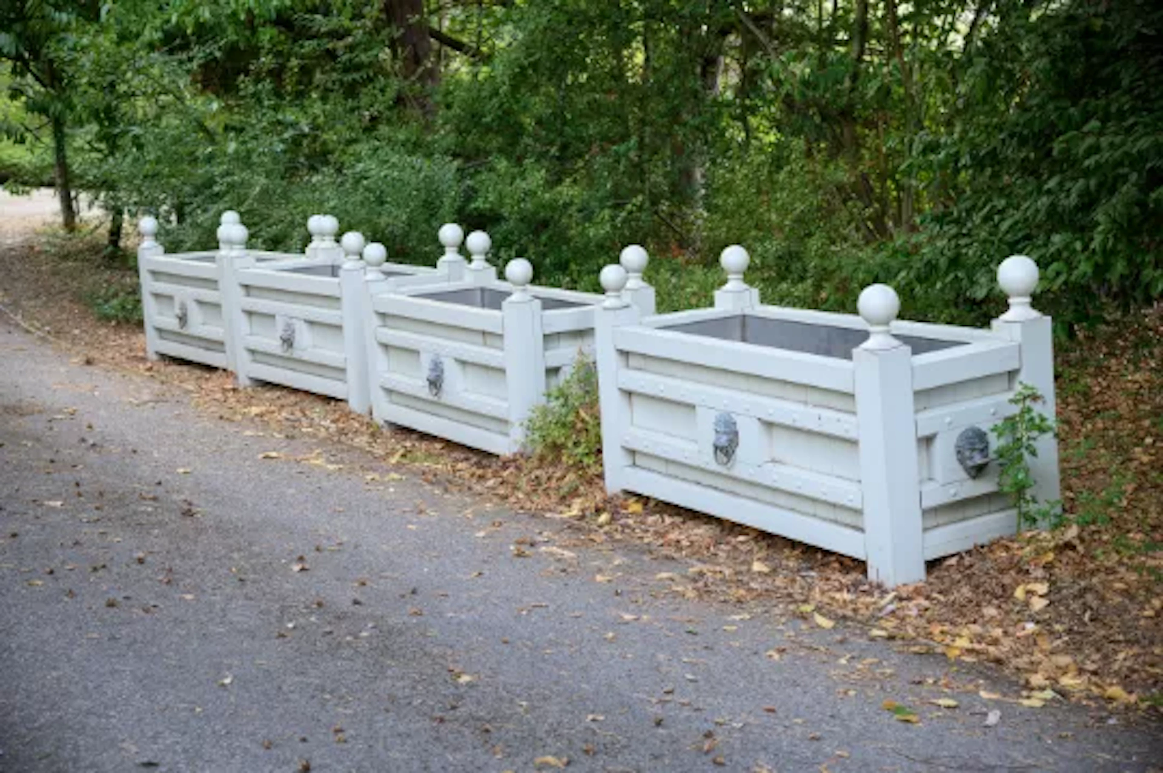 A SET OF FOUR GREY PAINTED TEAK AND BRASS MOUNTED RECTANGULAR PLANTERS