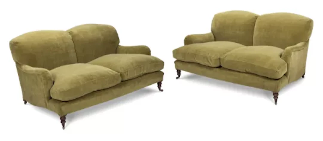 A PAIR OF TWO SEATER SOFAS, IN THE MANNER OF HOWARD & SON, MODERN