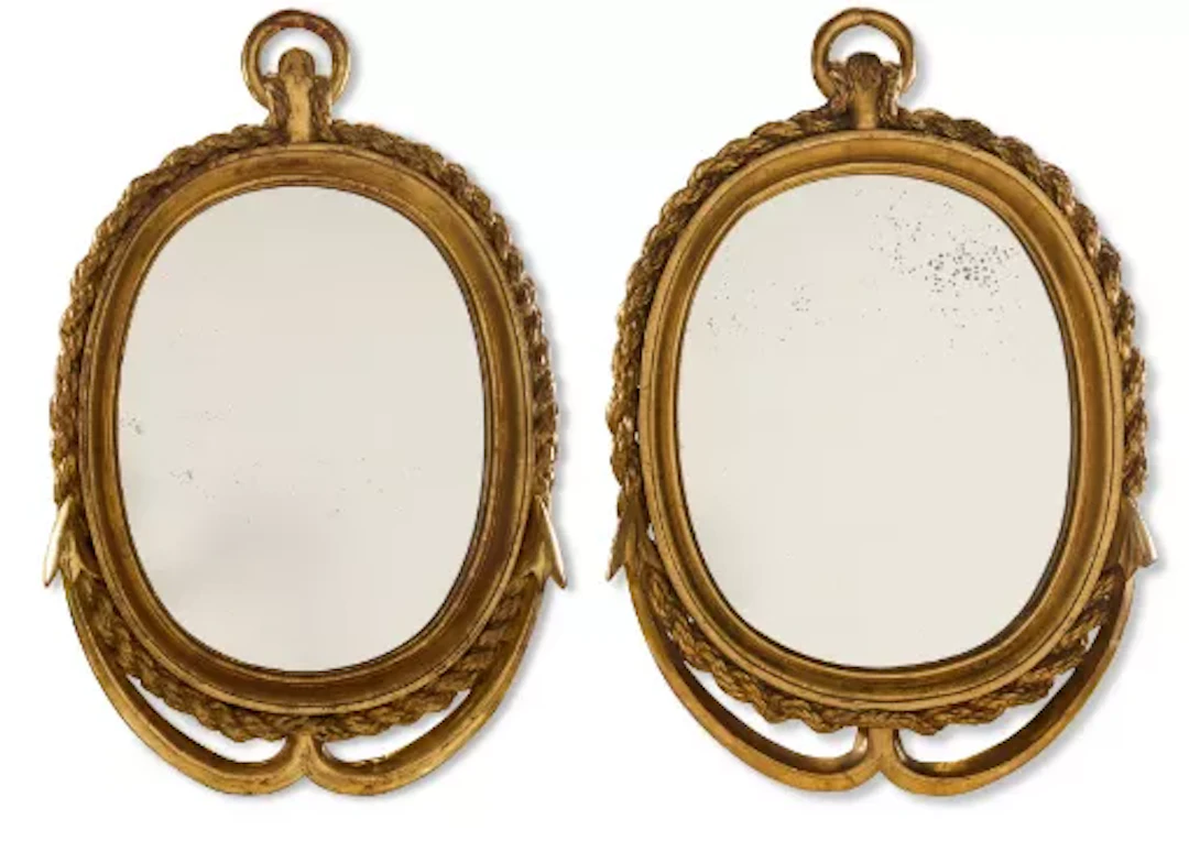 A PAIR OF GILTWOOD OVAL MIRRORS DECORATED WITH MARITIME MOTIFS, 19TH CENTURY