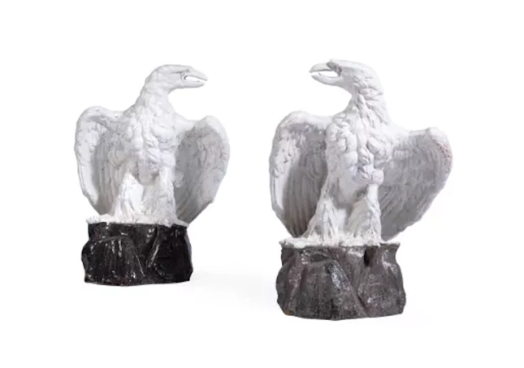 A PAIR OF CONTINENTAL WHITE-GLAZED TERRACOTTA MODELS OF EAGLES, EARLY