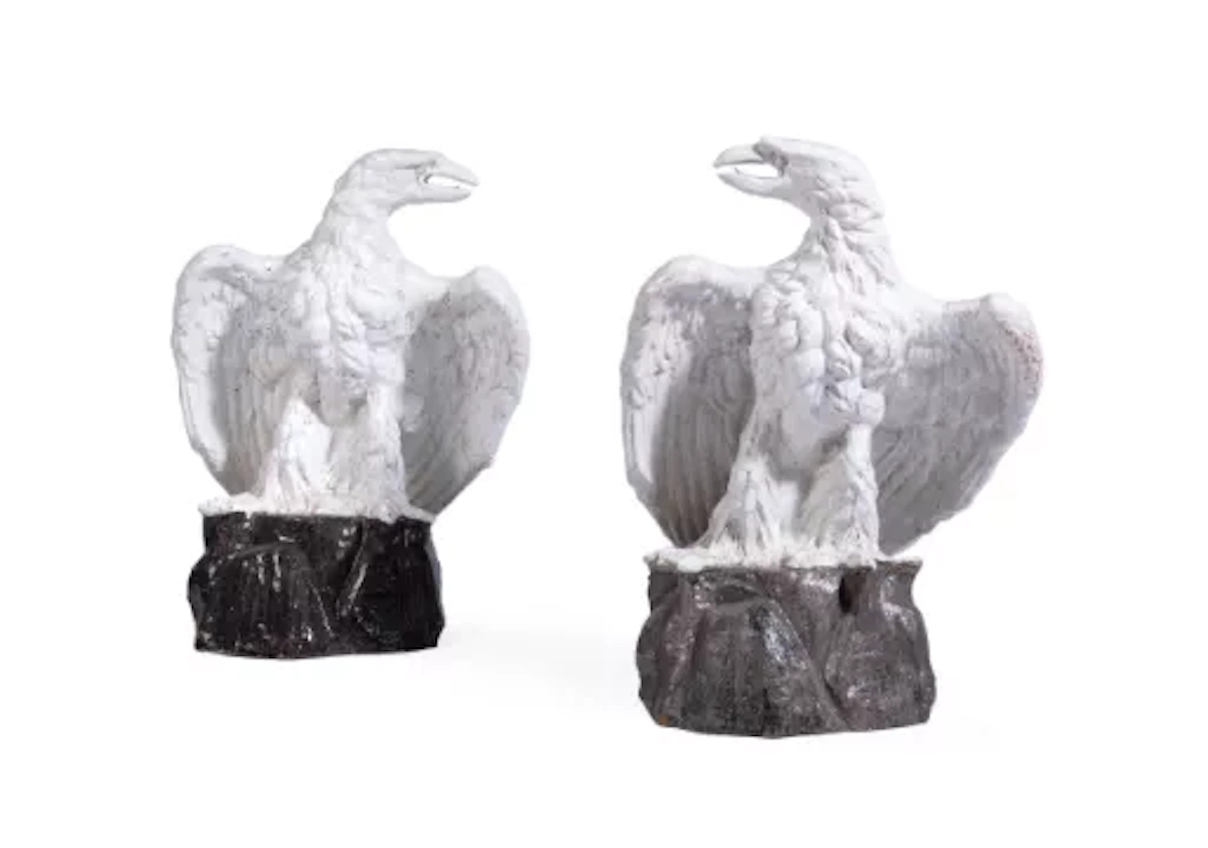A PAIR OF CONTINENTAL WHITE-GLAZED TERRACOTTA MODELS OF EAGLES, EARLY
