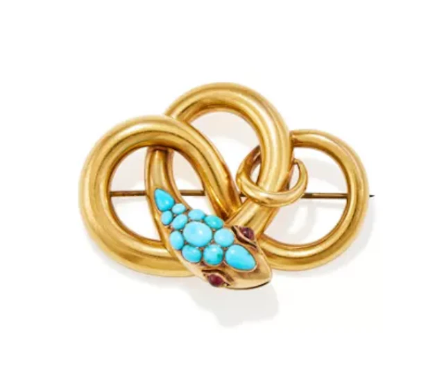 A MID VICTORIAN TURQUOISE AND GARNET SET SERPENT BROOCH, CIRCA 1870