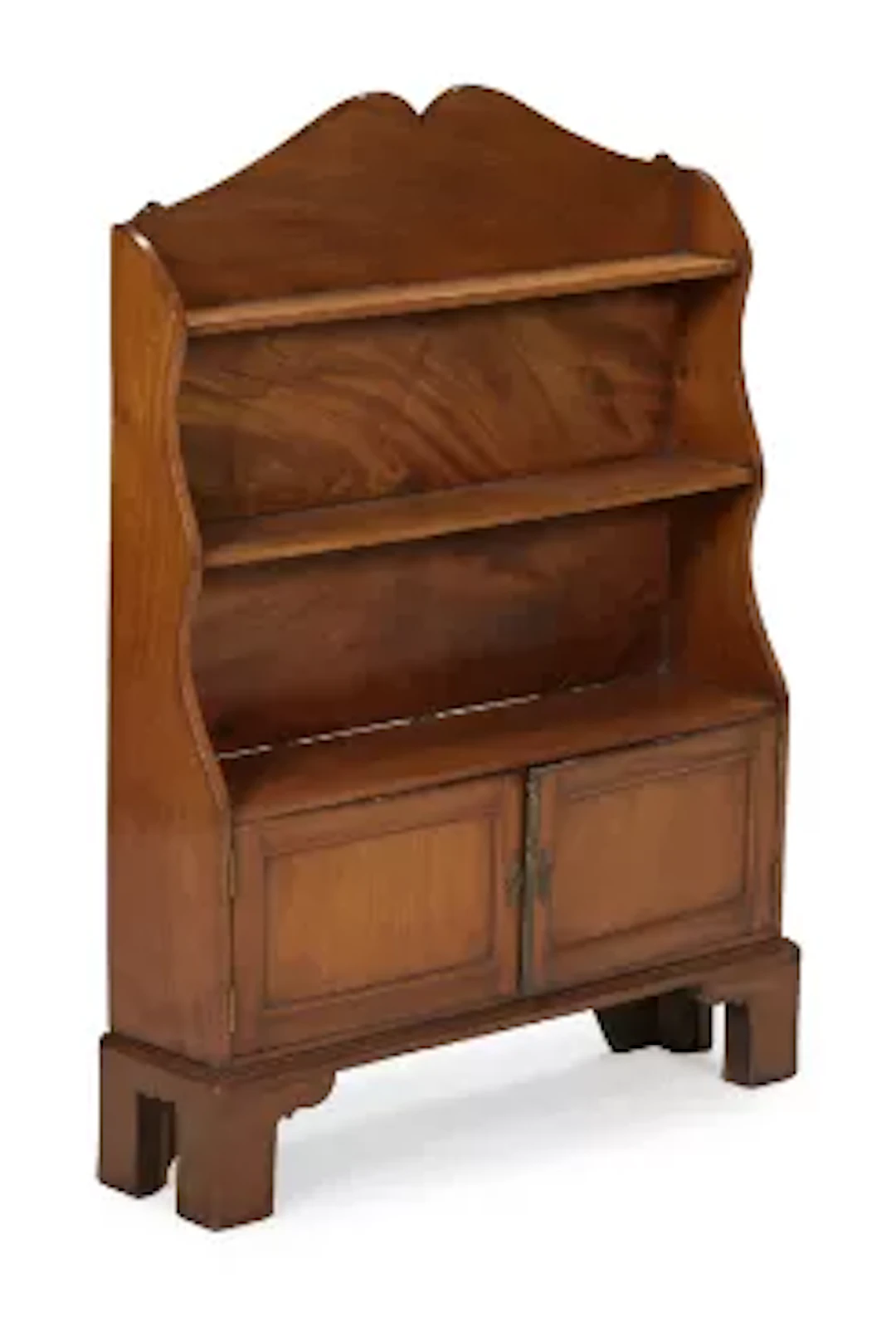 A SMALL MAHOGANY 'WATERFALL' CUPBOARD BOOKCASE, IN REGENCY STYLE