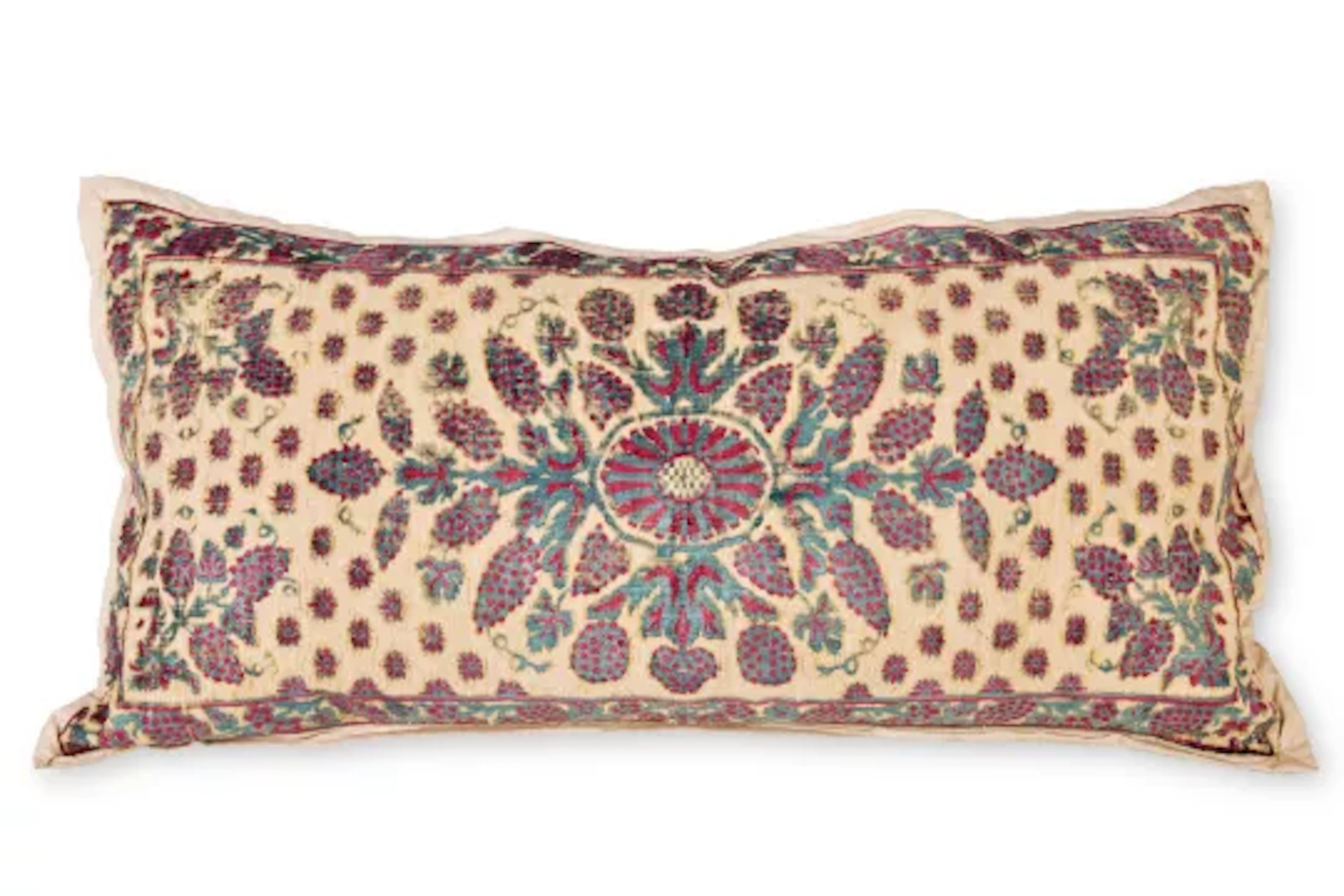 A BOLSTER CUSHION WITH NORTH INDIAN TEXTILE COVERING, MODERN INCORPORATING