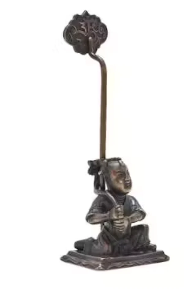 A Chinese bronze 'Boy' candle holder