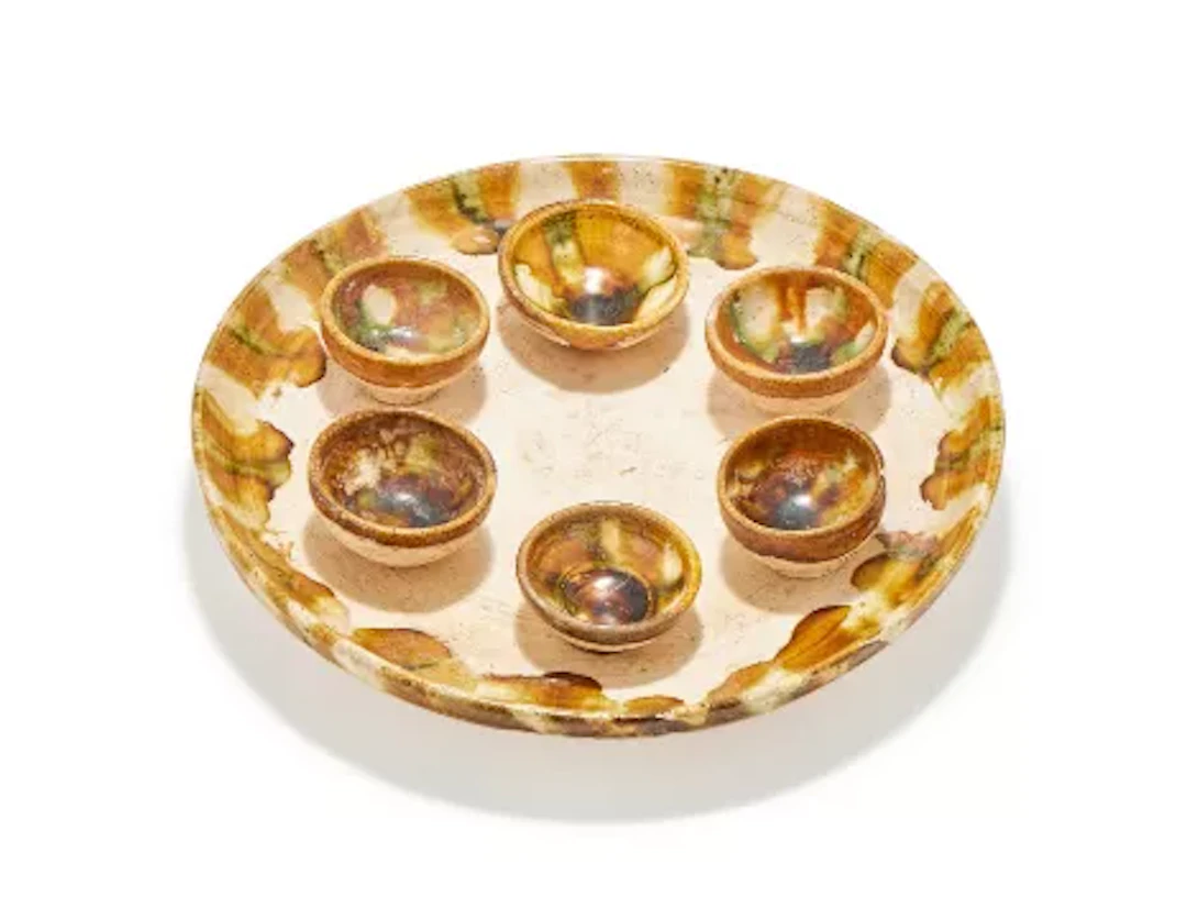 A Chinese pottery sancai glazed tray and six wine cups, presumed Tang dynasty