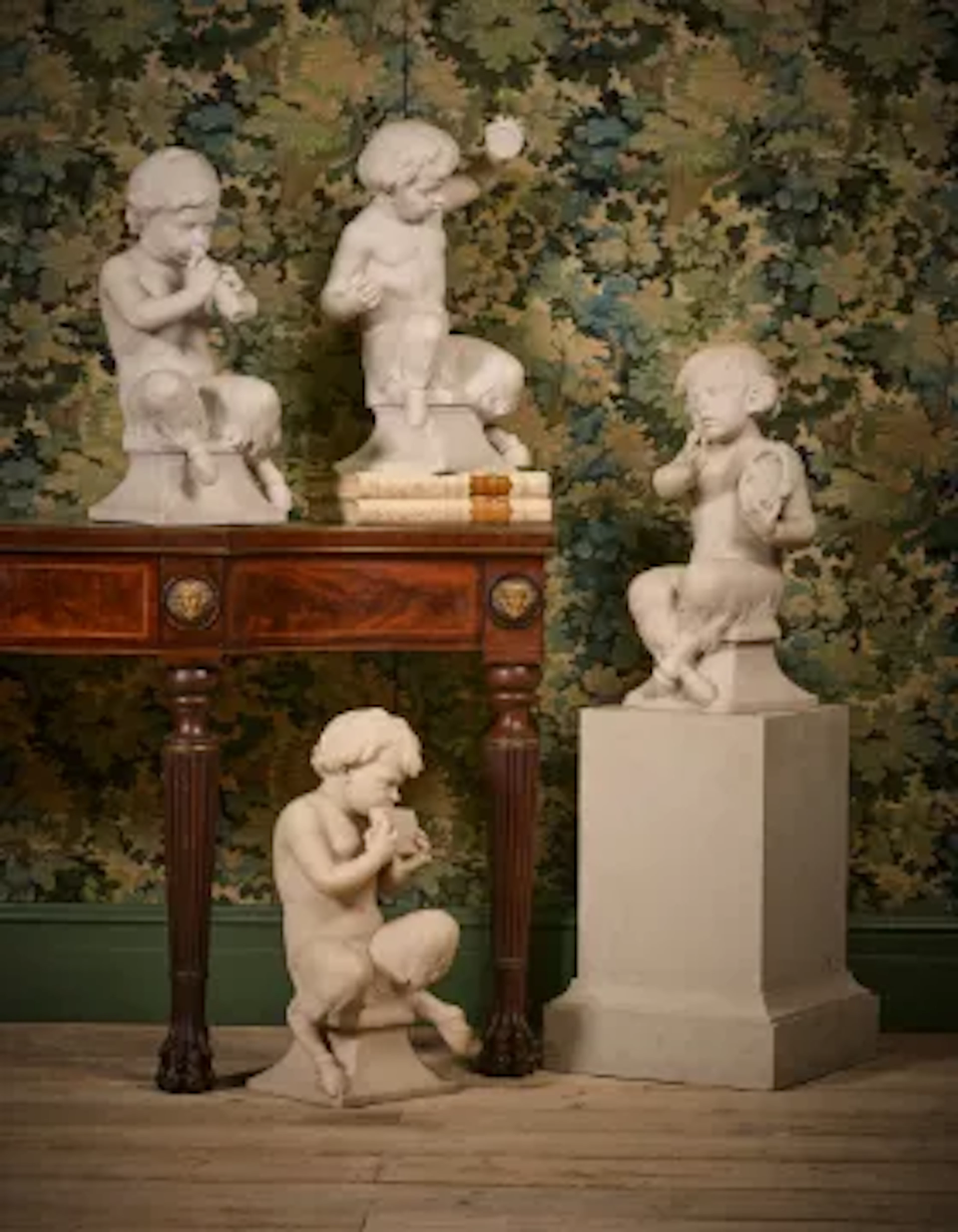A SET OF FOUR ITALIAN CARRARA MARBLE FAUNS, LATE 19TH CENTURY