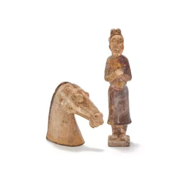 A Chinese brown glazed model of a standing official, Tang Dynasty (618-907)