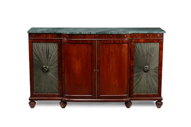 A GEORGE IV MAHOGANY BREAKFRONT SIDE CABINET, IN THE MANNER OF HOLLAND