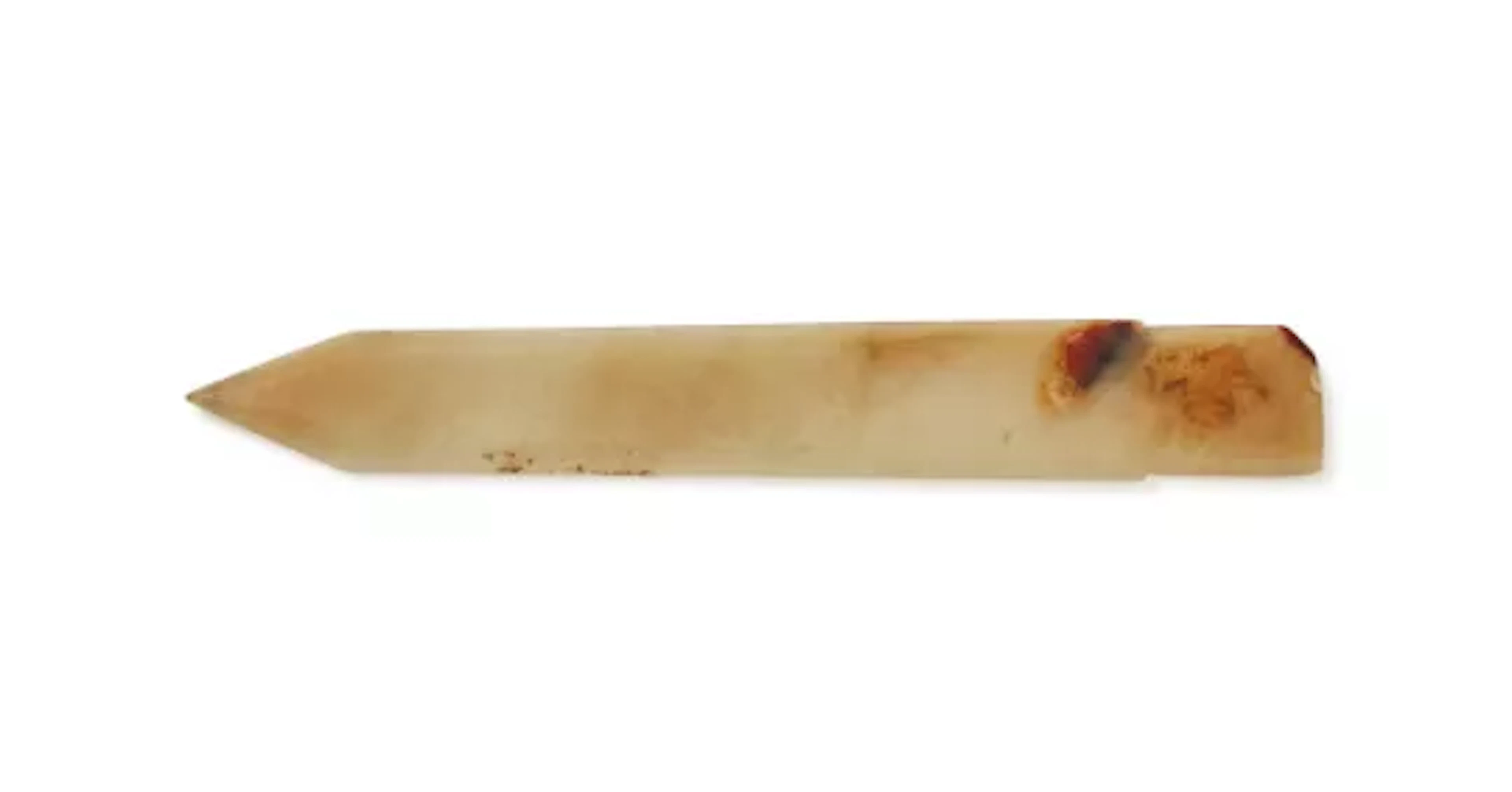 A Chinese celadon and russet jade dagger axe, ge, Late Shang Dynasty