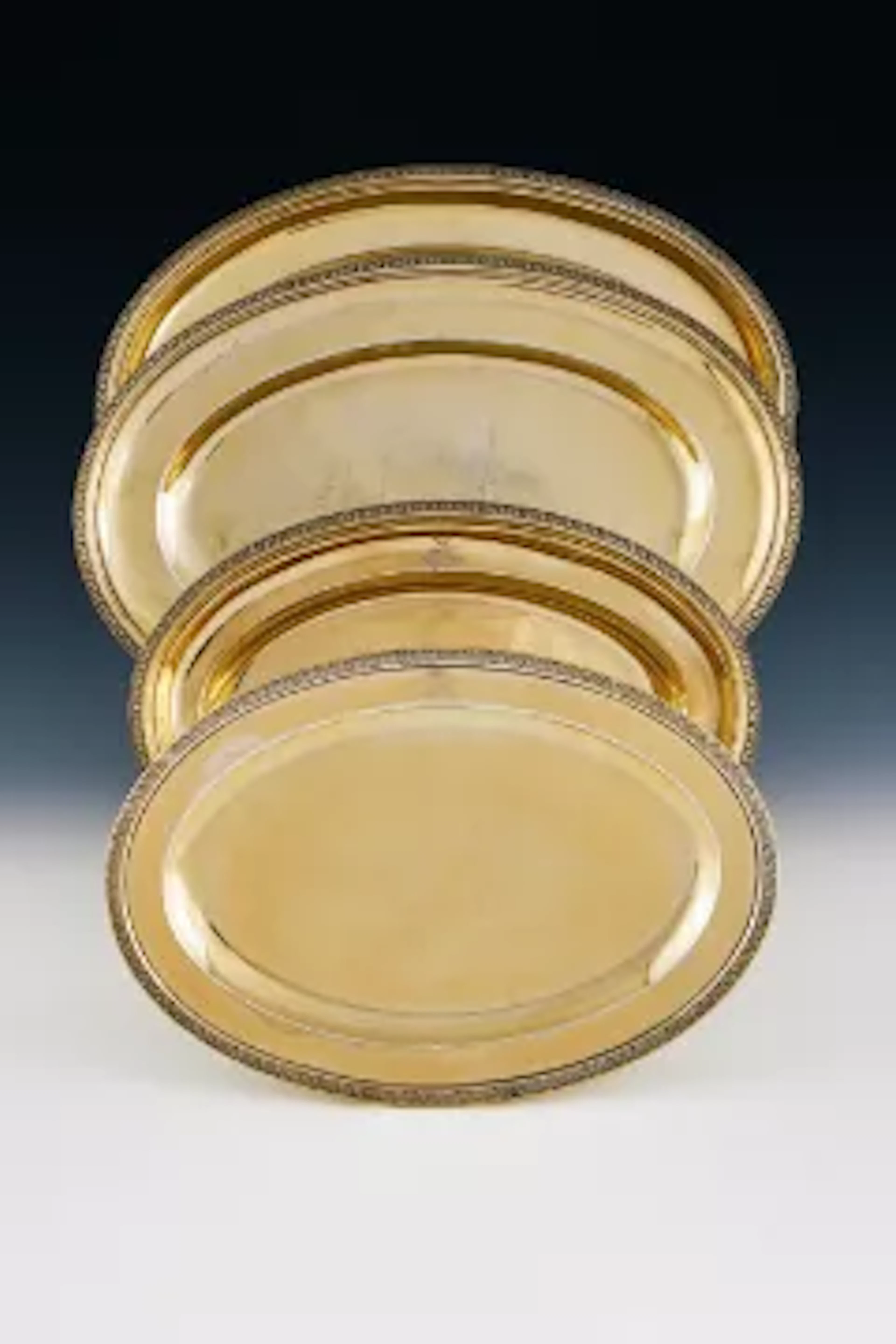 A SET OF THREE FRENCH EMPIRE SILVER GILT OVAL SERVING DISHES, SIGNED