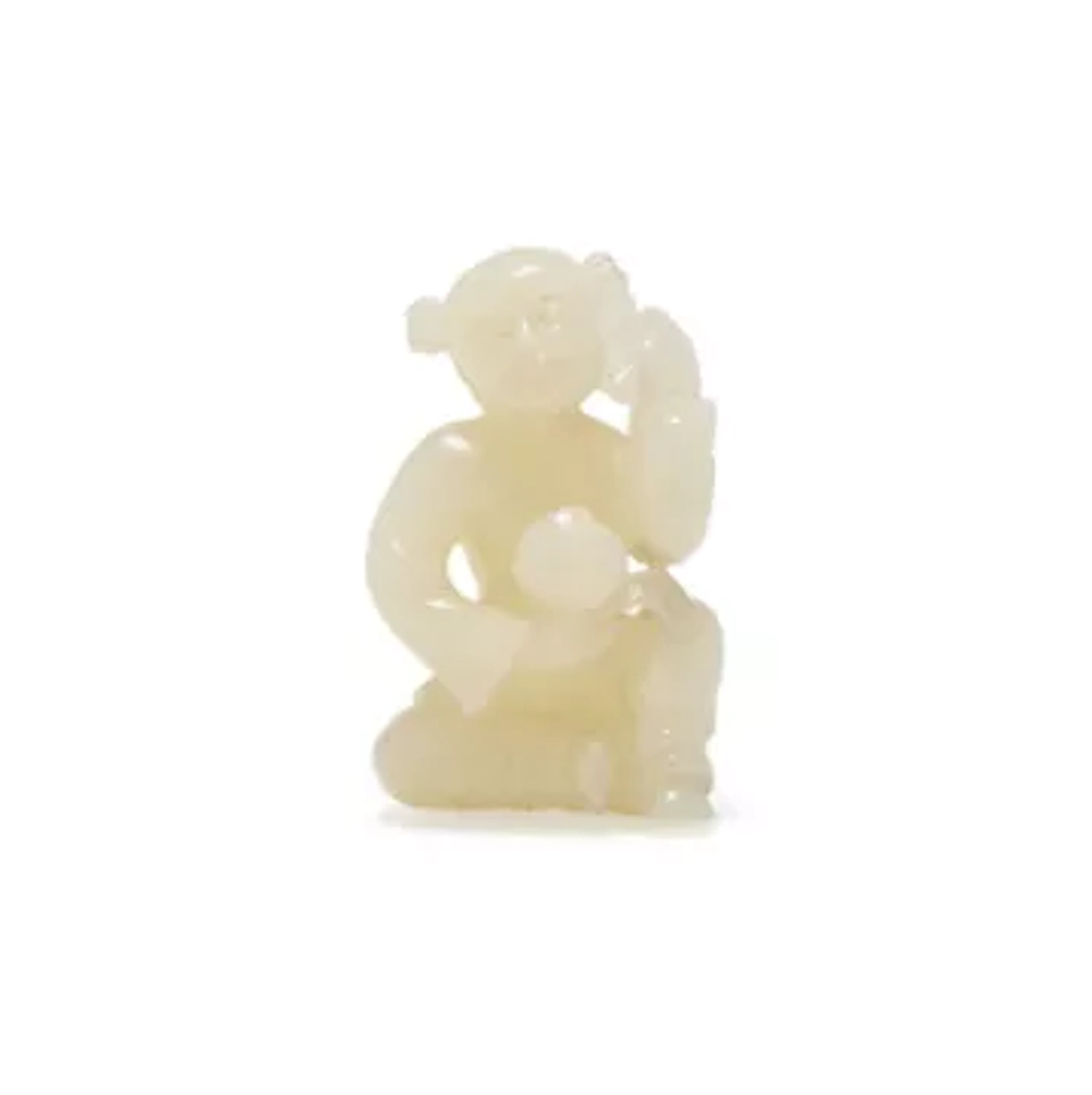 A Chinese white jade model of a seated boy
