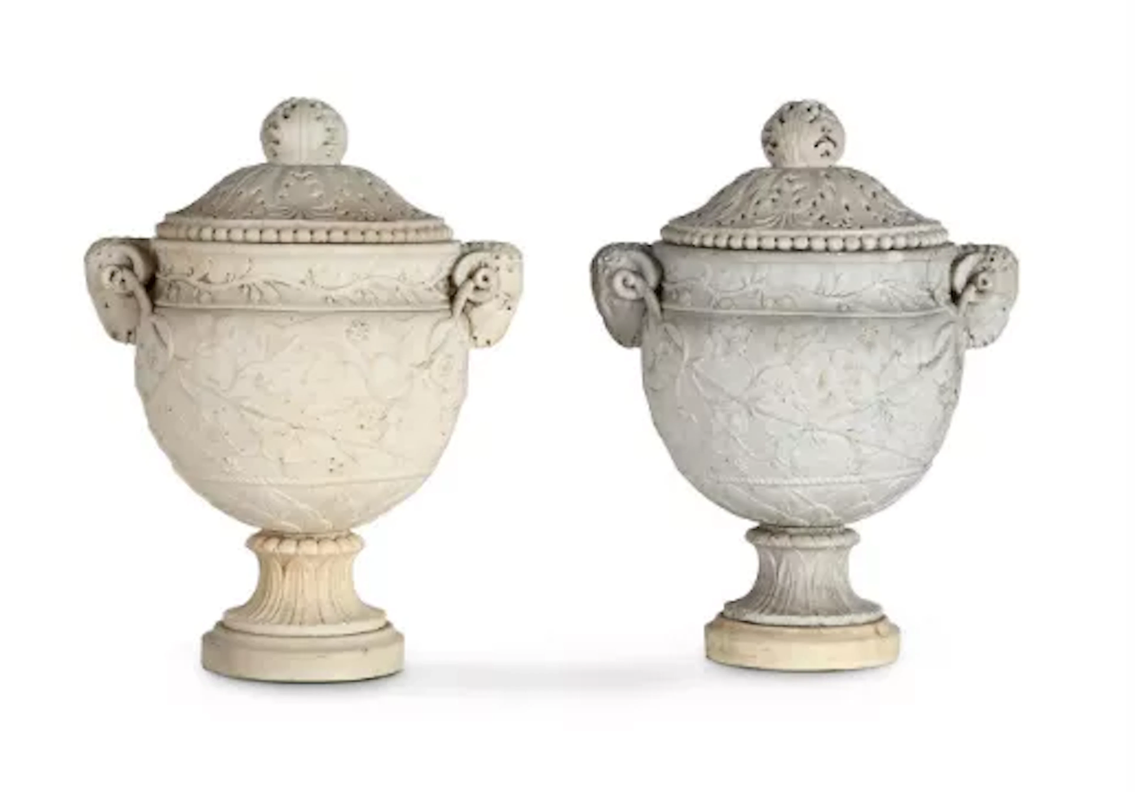 AFTER THE ANTIQUE, A MATCHED PAIR OF CARVED WHITE MARBLE 'PIRANESI' URNS