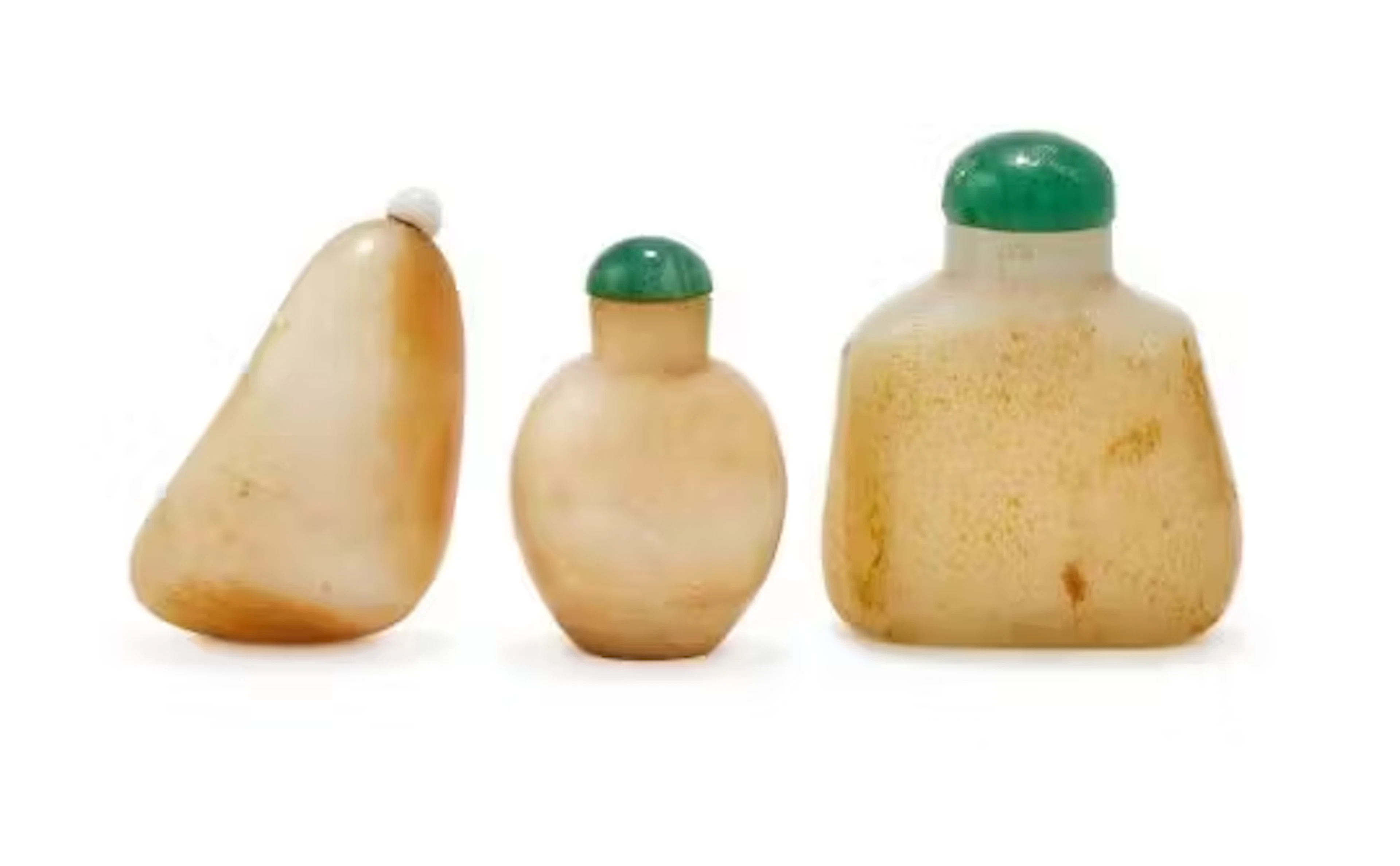 A group of three Chinese white and russet jade snuff bottles