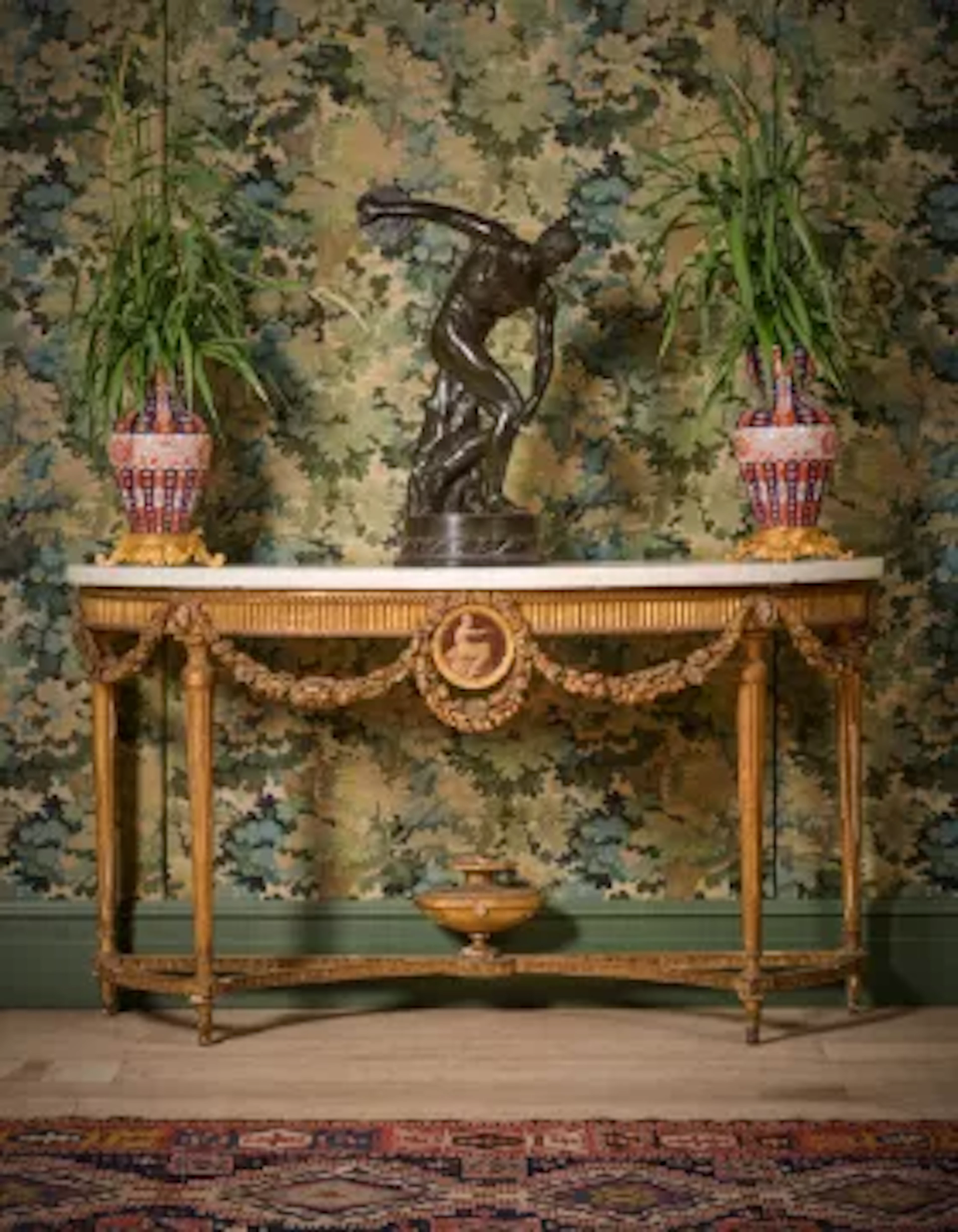 A GEORGE III CARVED GILTWOOD, GESSO AND PAINTED CONSOLE OR SIDE TABLE