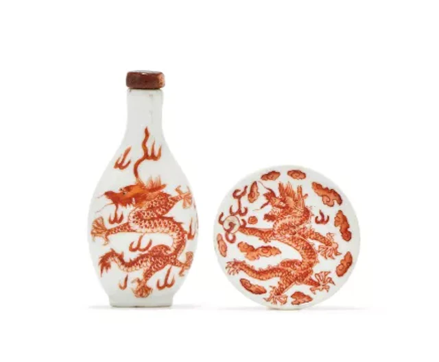 A Chinese iron red 'Dragon' porcelain snuff bottle and saucer, Daoguang