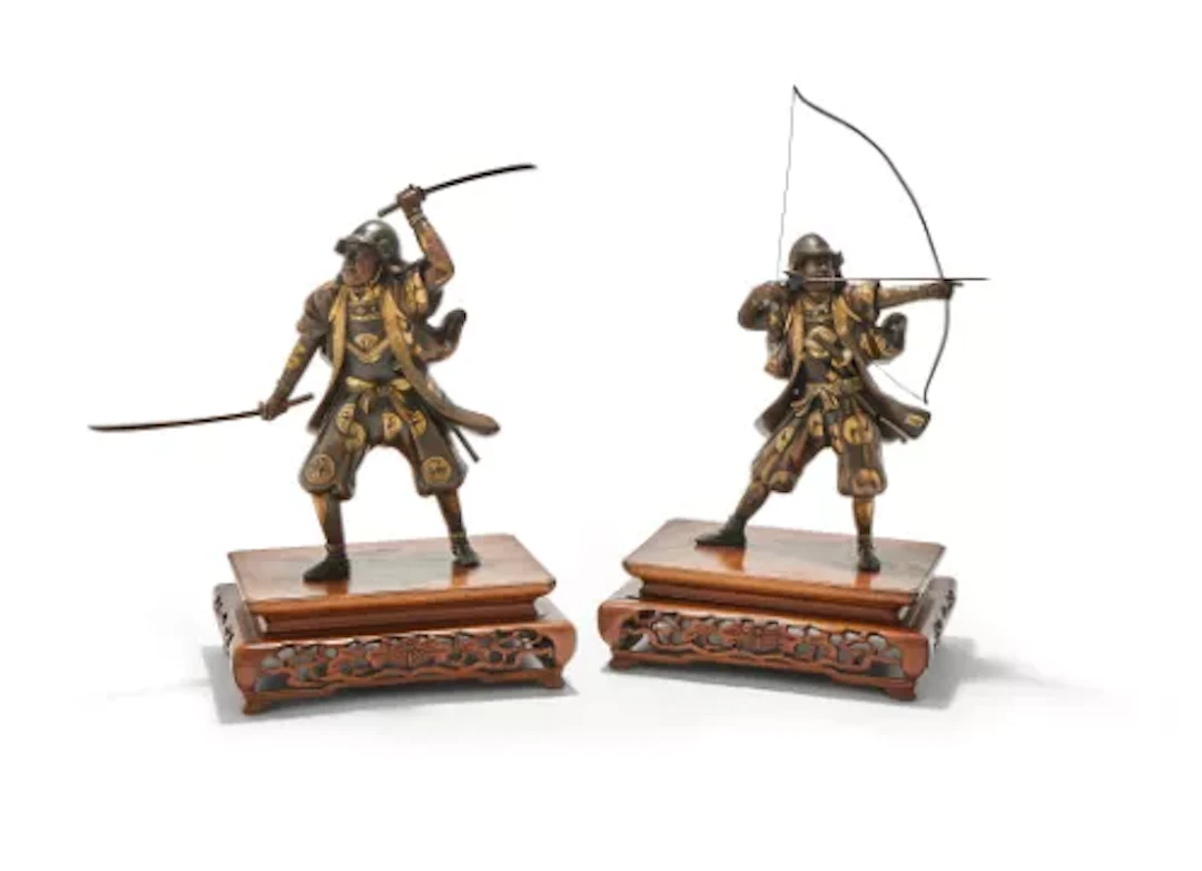 An attractive pair of Japanese parcel gilt bronze figures of warriors