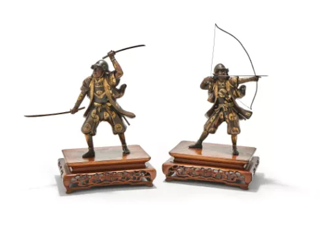 An attractive pair of Japanese parcel gilt bronze figures of warriors