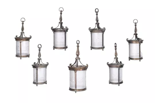 A SET OF SEVEN EDWARDIAN GILT BRONZE AND FROSTED GLASS HANGING LANTERNS