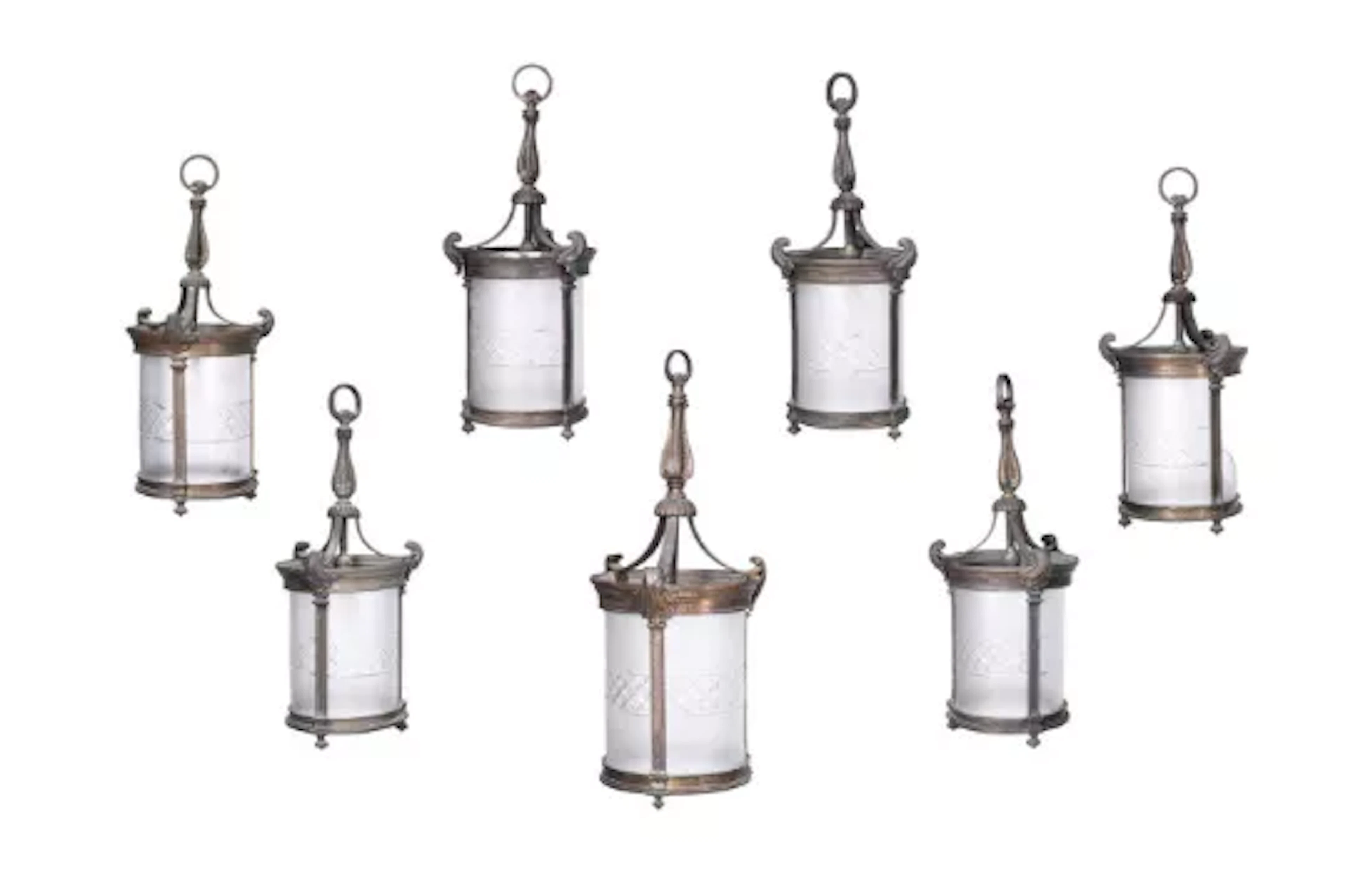 A SET OF SEVEN EDWARDIAN GILT BRONZE AND FROSTED GLASS HANGING LANTERNS