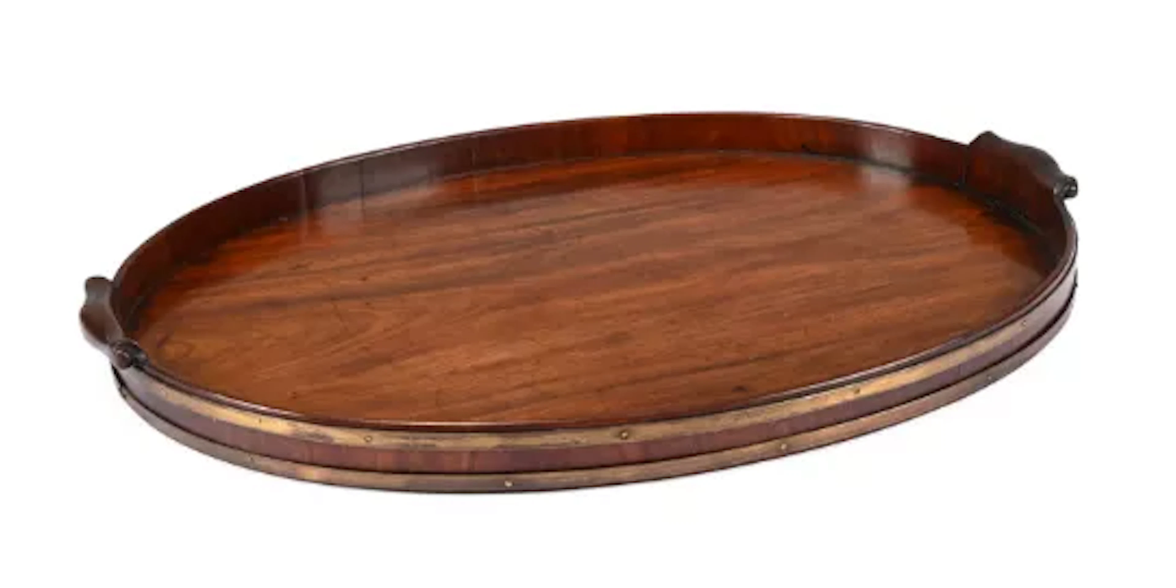 A GEORGE III MAHOGANY AND BRASS BOUND TRAY, IN THE MANNER OF THOMAS