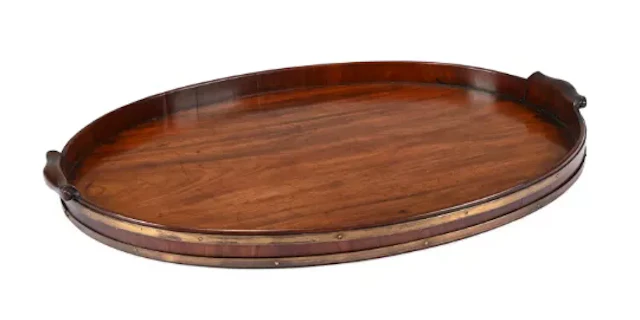 A GEORGE III MAHOGANY AND BRASS BOUND TRAY, IN THE MANNER OF THOMAS