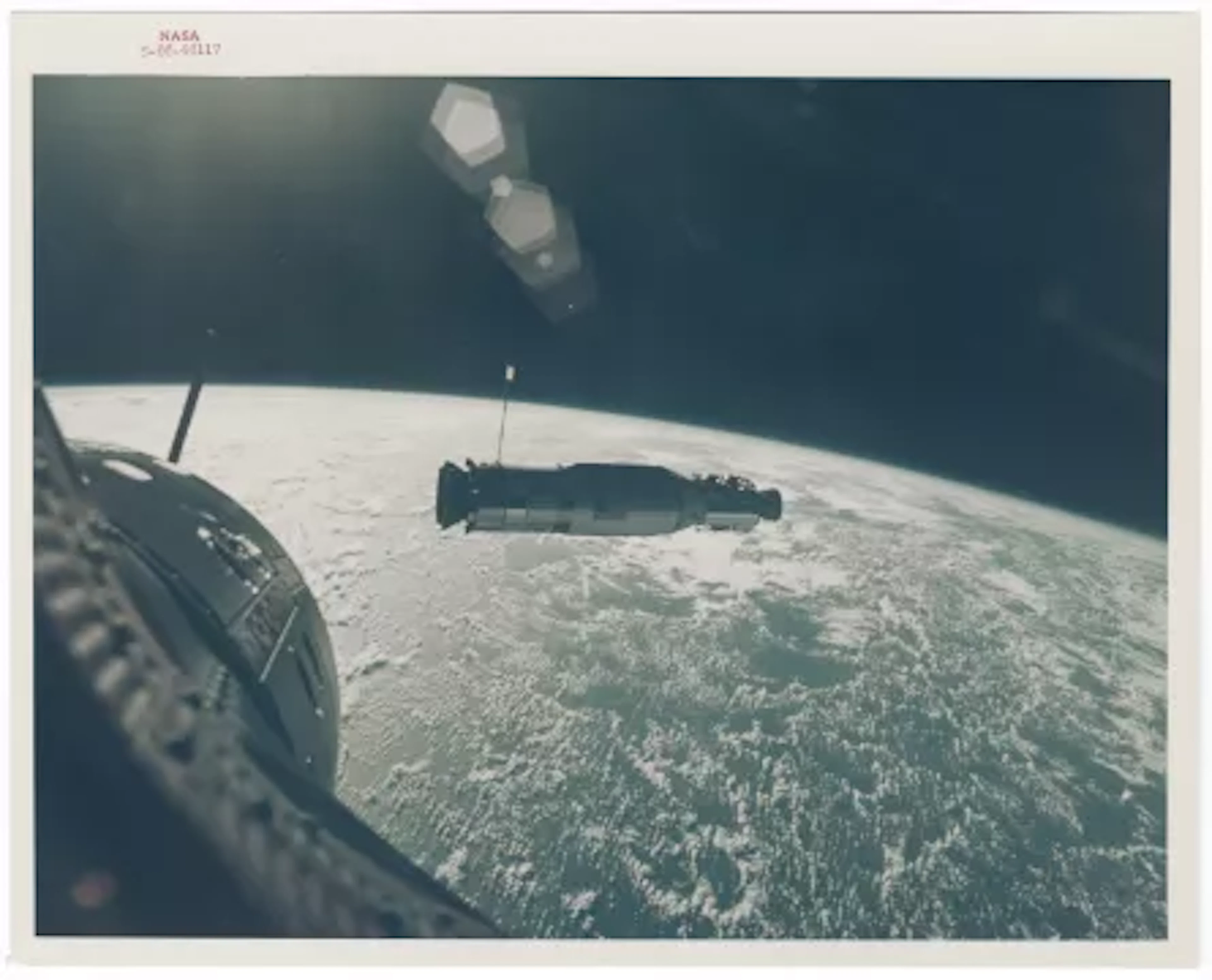 [Gemini X] COVER OF LIFE: SUN-ILLUMINATED AGENA SET AGAINST THE CURVATURE