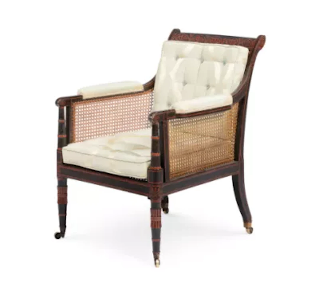 A REGENCY PAINTED BERGERE LIBRARY ARMCHAIR, IN THE MANNER OF THOMAS
