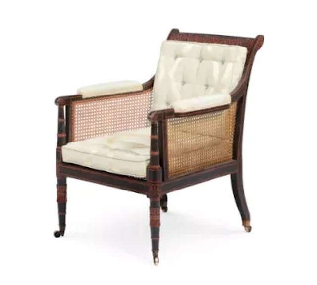 A REGENCY PAINTED BERGERE LIBRARY ARMCHAIR, IN THE MANNER OF THOMAS