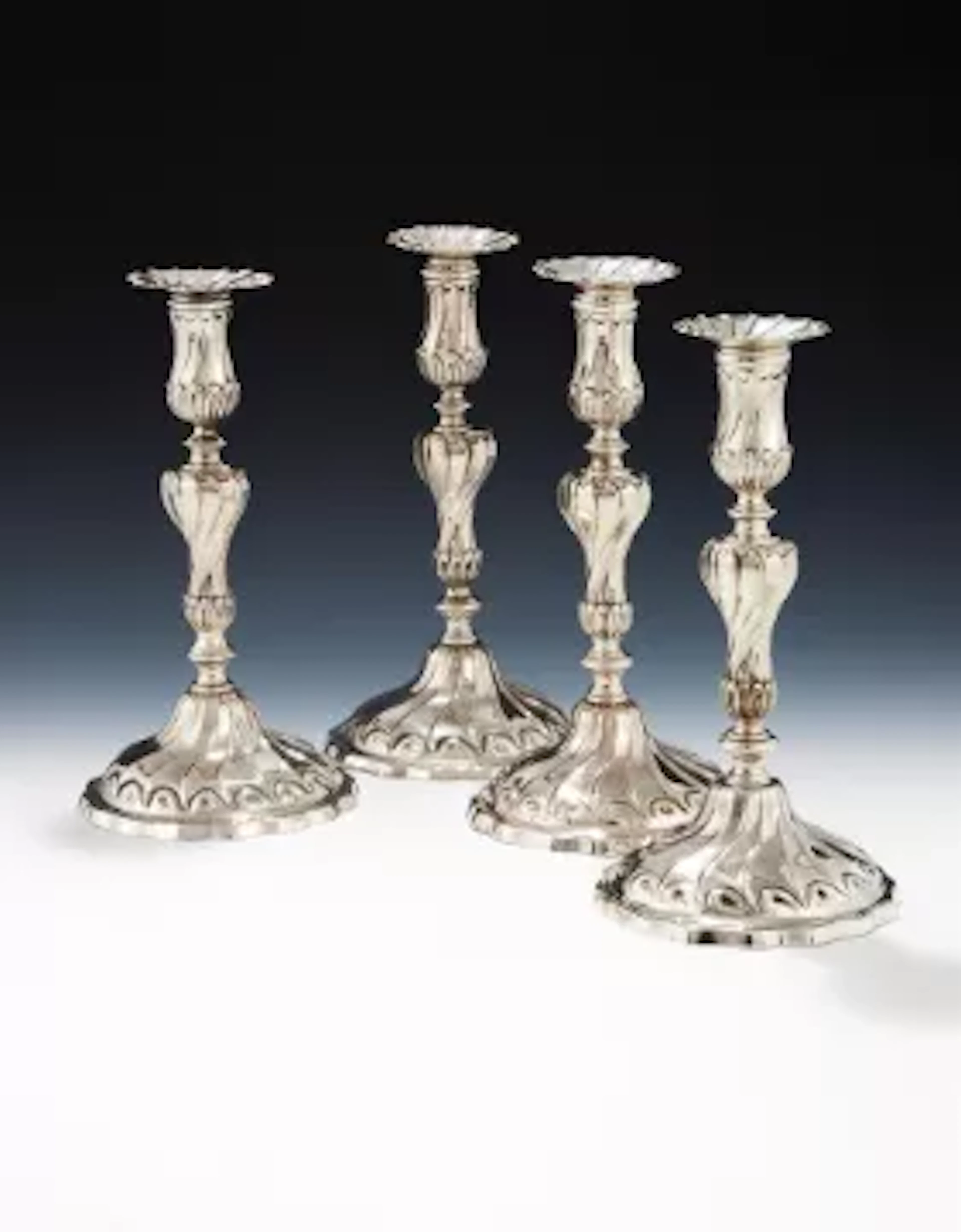 A SET OF FOUR GEORGE III CAST SILVER CANDLESTICKSTHOMAS HEMING