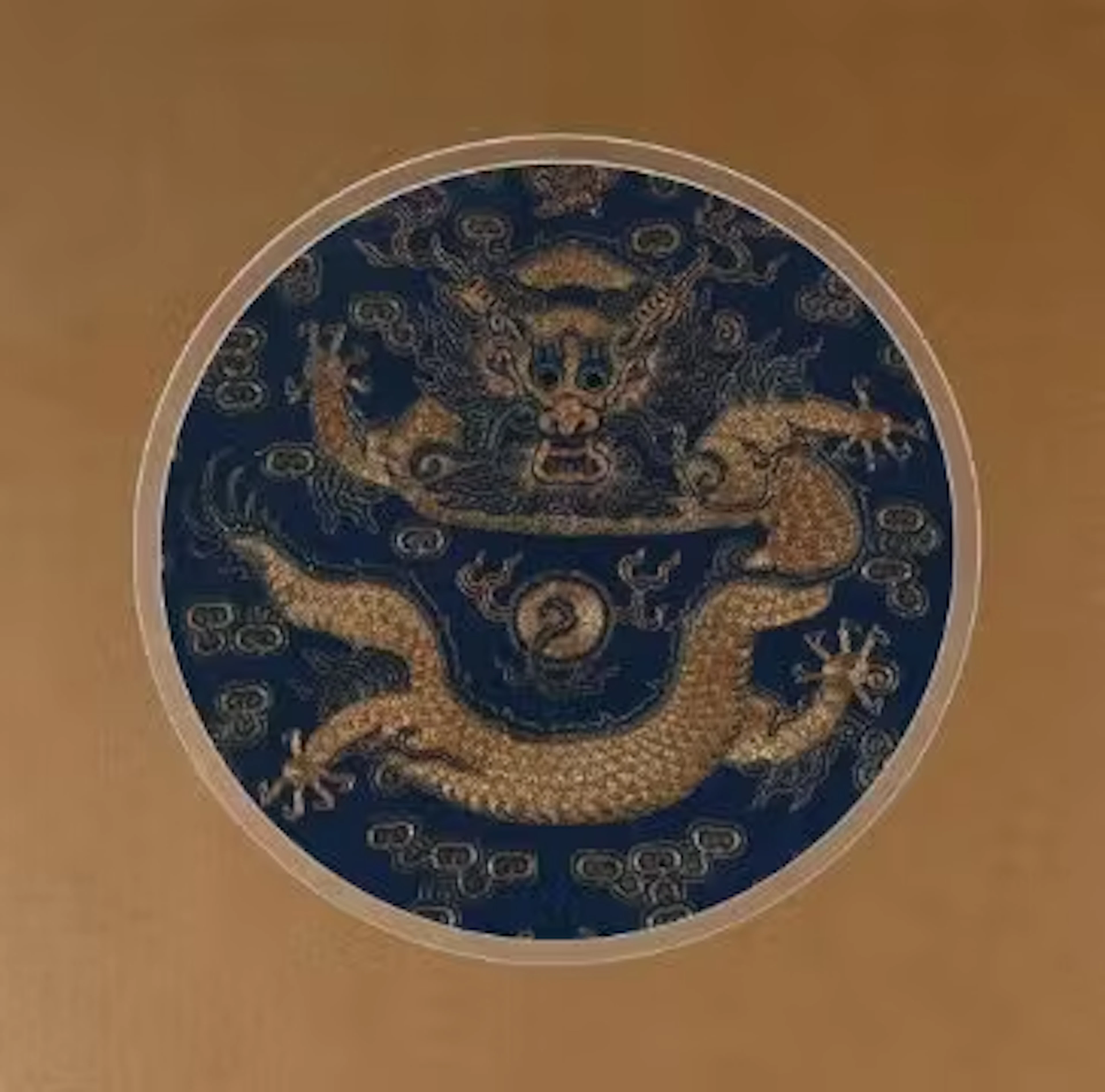 † A Chinese silk front facing 'dragon' roundel from a dragon robe