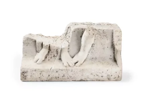 A ROMAN MARBLE RELIEF CARVED WITH PARTIALLY PRESERVED LOWER LEGS AND