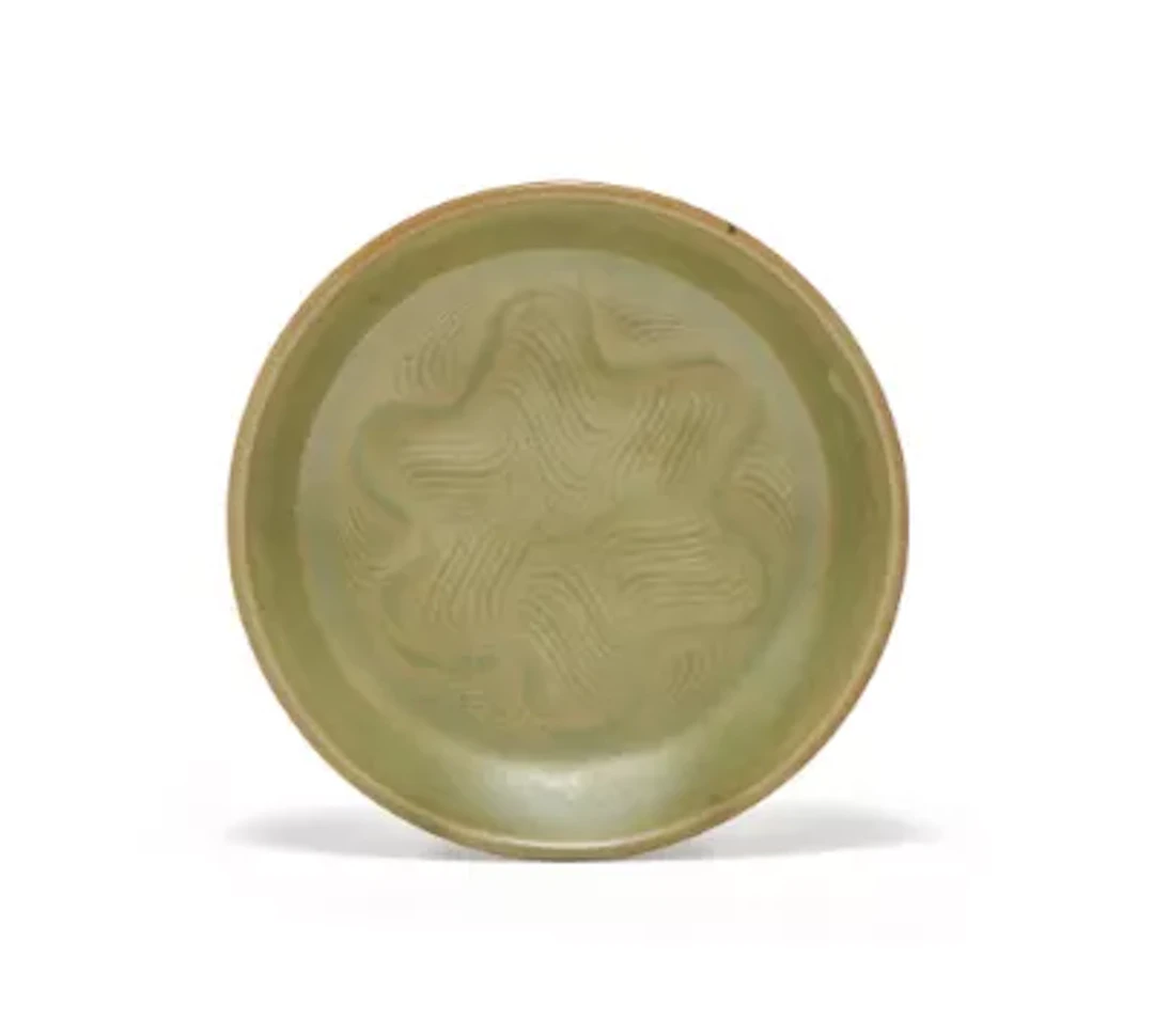 A Chinese small carved Yaozhou celadon dish, Northern Song dynasty (960-1127)