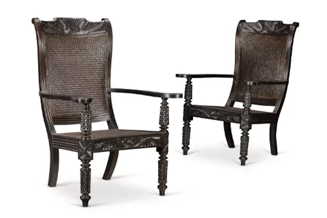Y‡ A PAIR OF CEYLONESE EBONY AND CANED ARMCHAIRS, FIRST HALF 20TH CENTURY