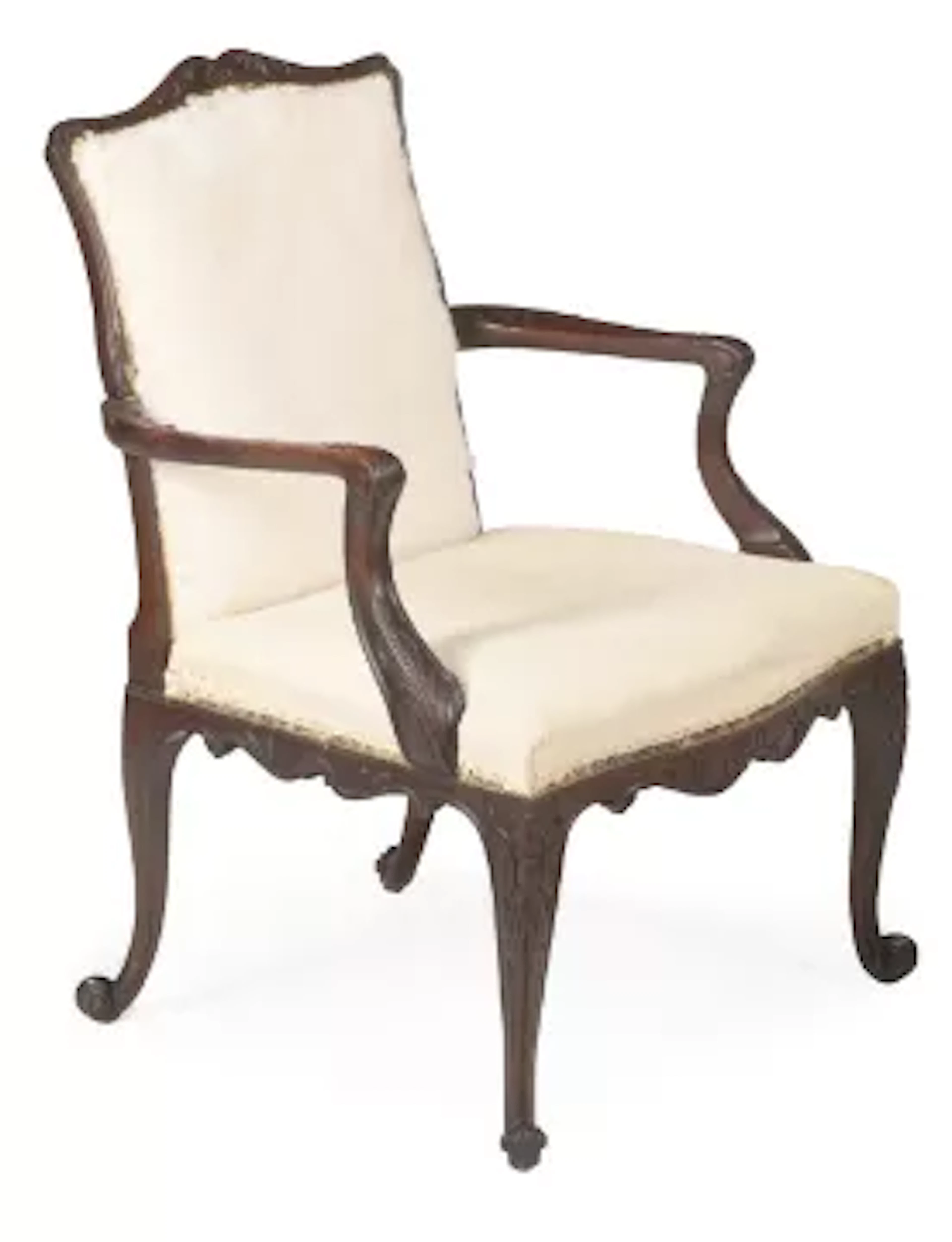 A GEORGE III CARVED MAHOGANY LIBRARY ARMCHAIR, IN THE MANNER OF PAUL