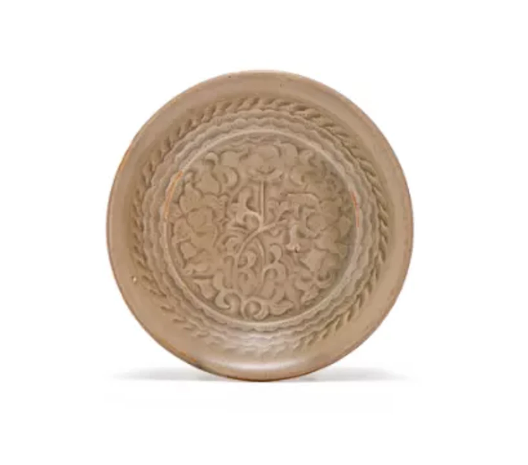 A Chinese Yaozhou moulded 'flower' dish, Northern Song dynasty, 11-12th century
