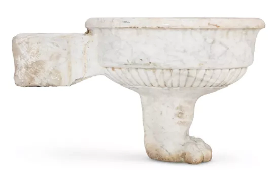 A CARVED WHITE MARBLE LION FOOT OVAL BASIN , 19TH CENTURY