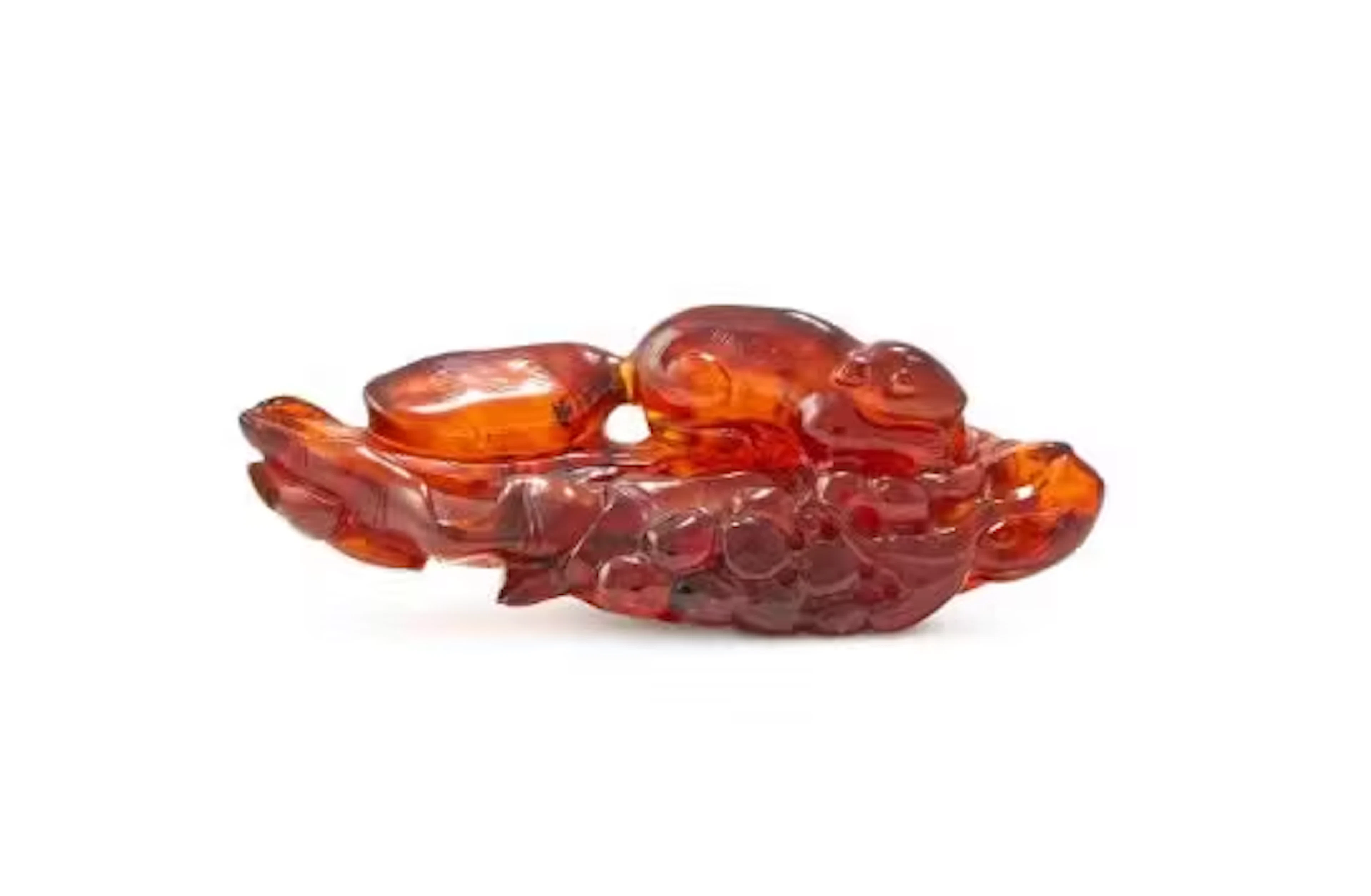 A large Chinese carved amber 'Squirrel and grape' ink palette