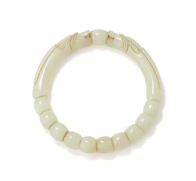 A Chinese pale celadon 'Dragon' bangle, 17th century