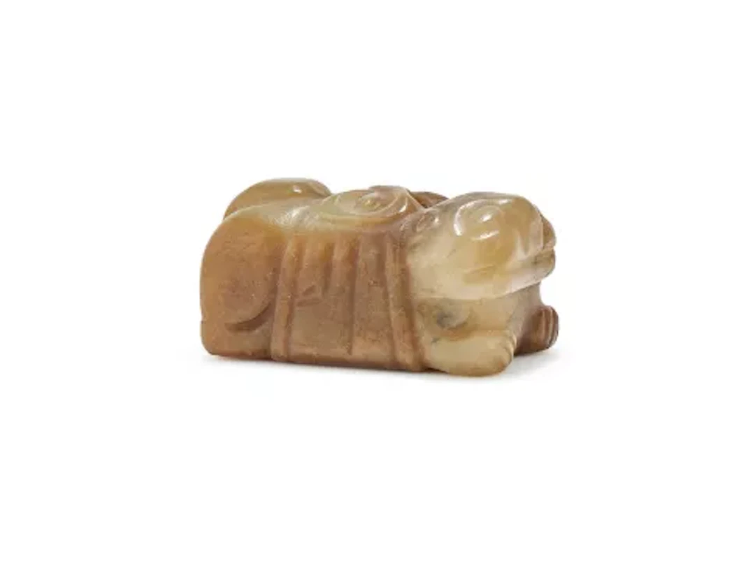 A group of three Chinese carved jade pendants