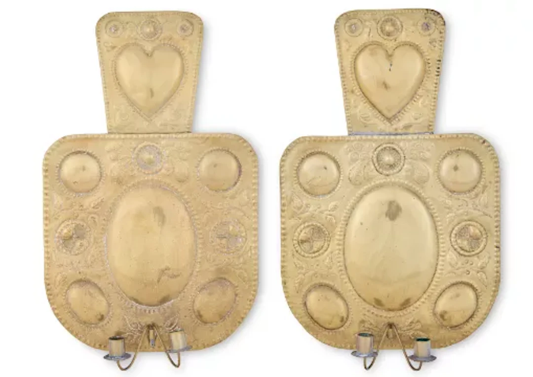 A PAIR OF ARTS AND CRAFTS REPOUSSE DECORATED BRASS TWIN LIGHT WALL