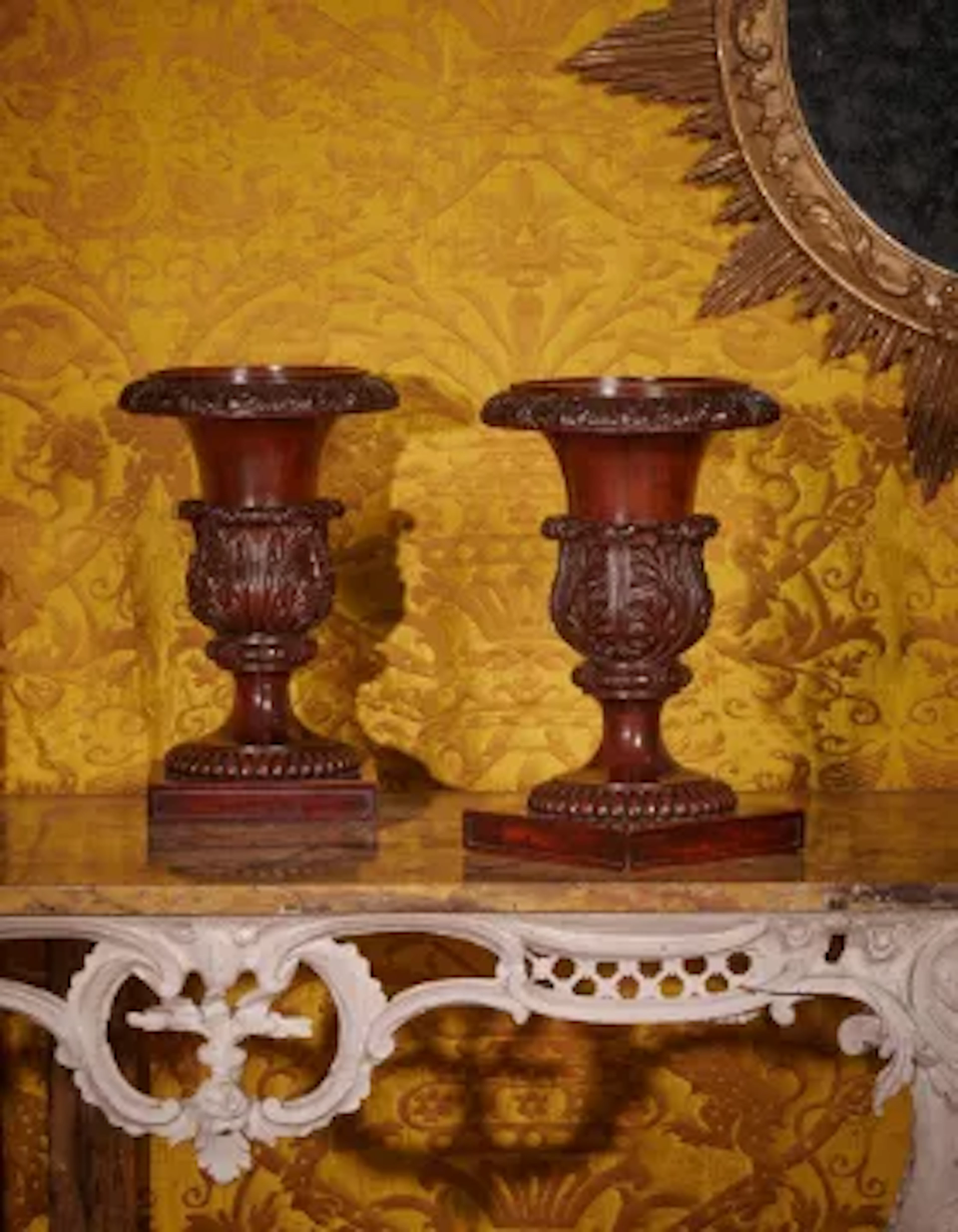 A PAIR OF REGENCY SOLID CARVED MAHOGANY VASES OR STANDS, ATTRIBUTED