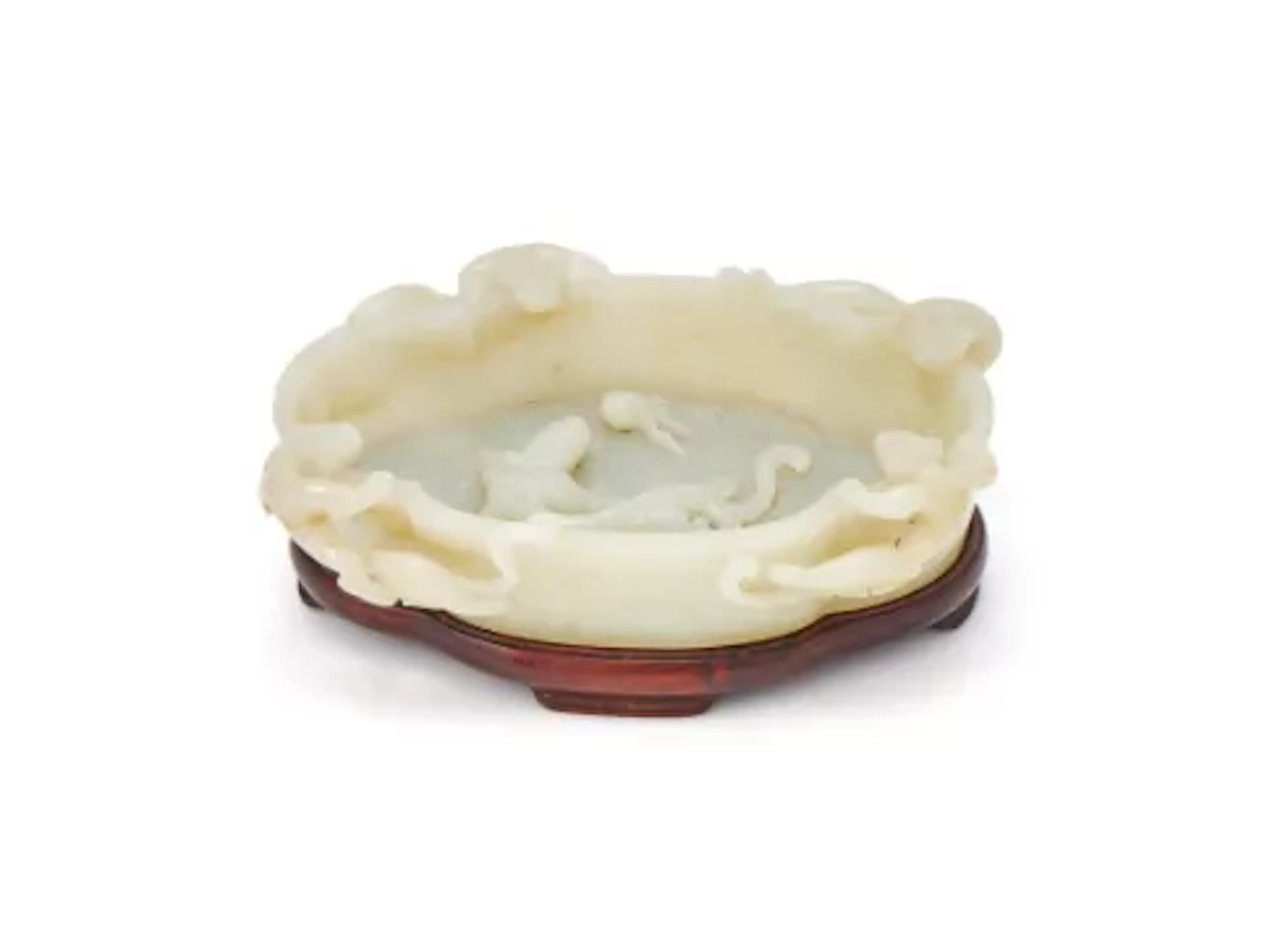 A Chinese white jade ‘Dragons’ washer, Qing Dynasty