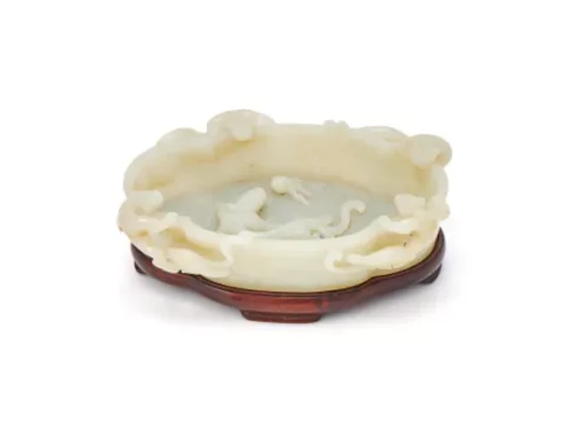 A Chinese white jade ‘Dragons’ washer, Qing Dynasty