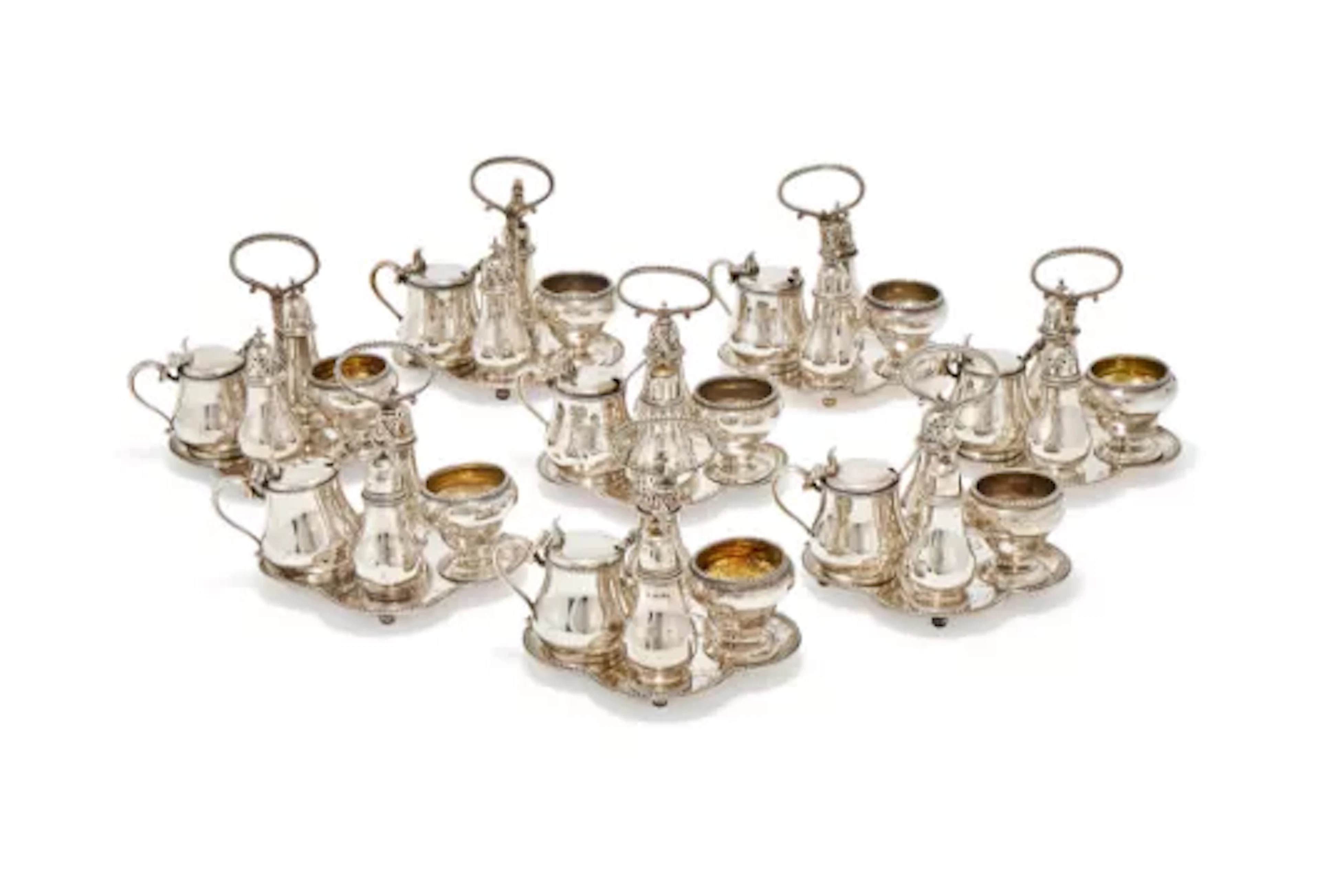 A MATCHED SET OF EIGHT VICTORIAN SILVER FOUR PIECE CRUETS ON STANDS