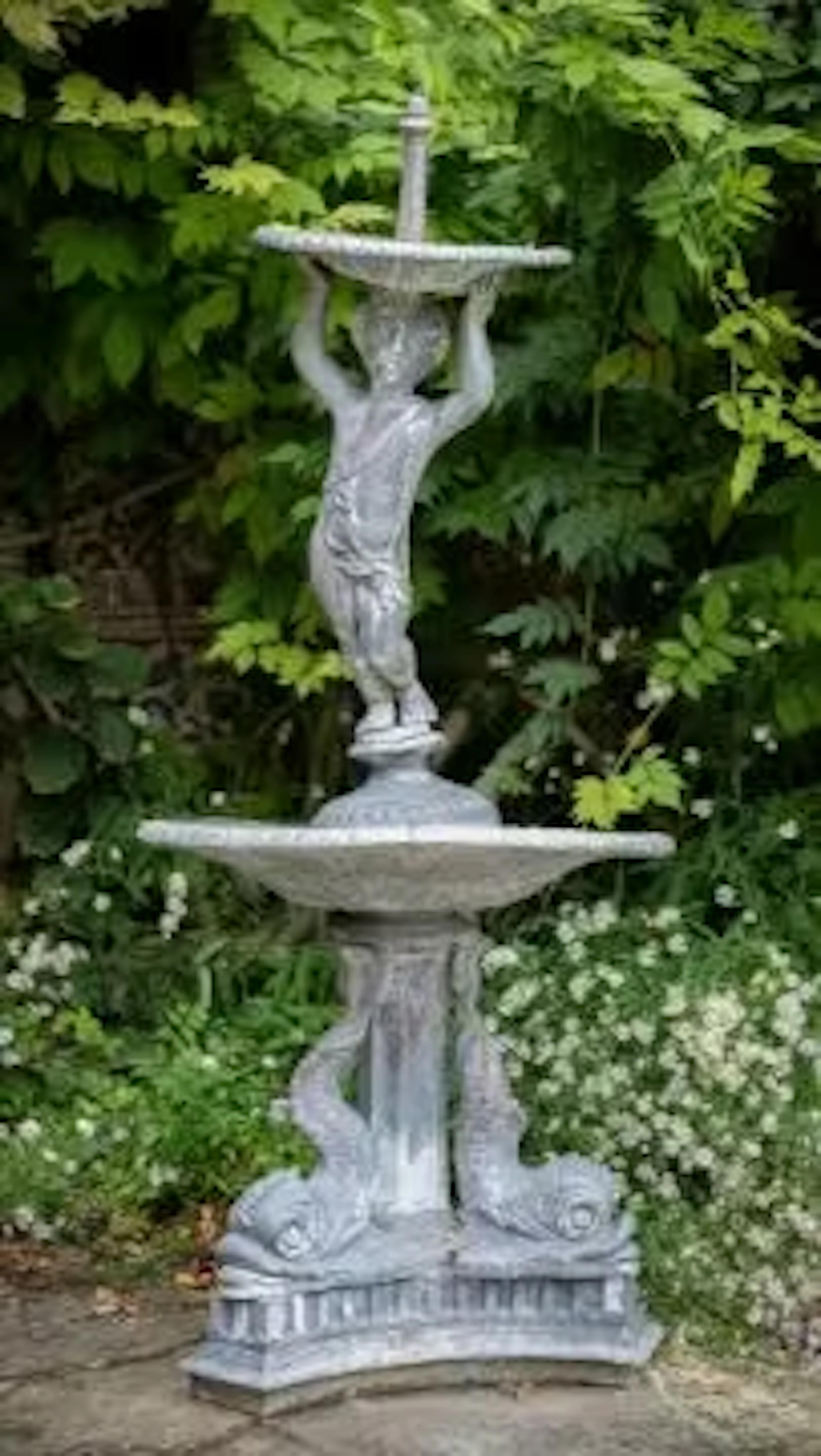 A LEAD FOUNTAIN WITH A PUTTO SURMOUNT ON ADDORSED DOLPHIN BASE, MODERN